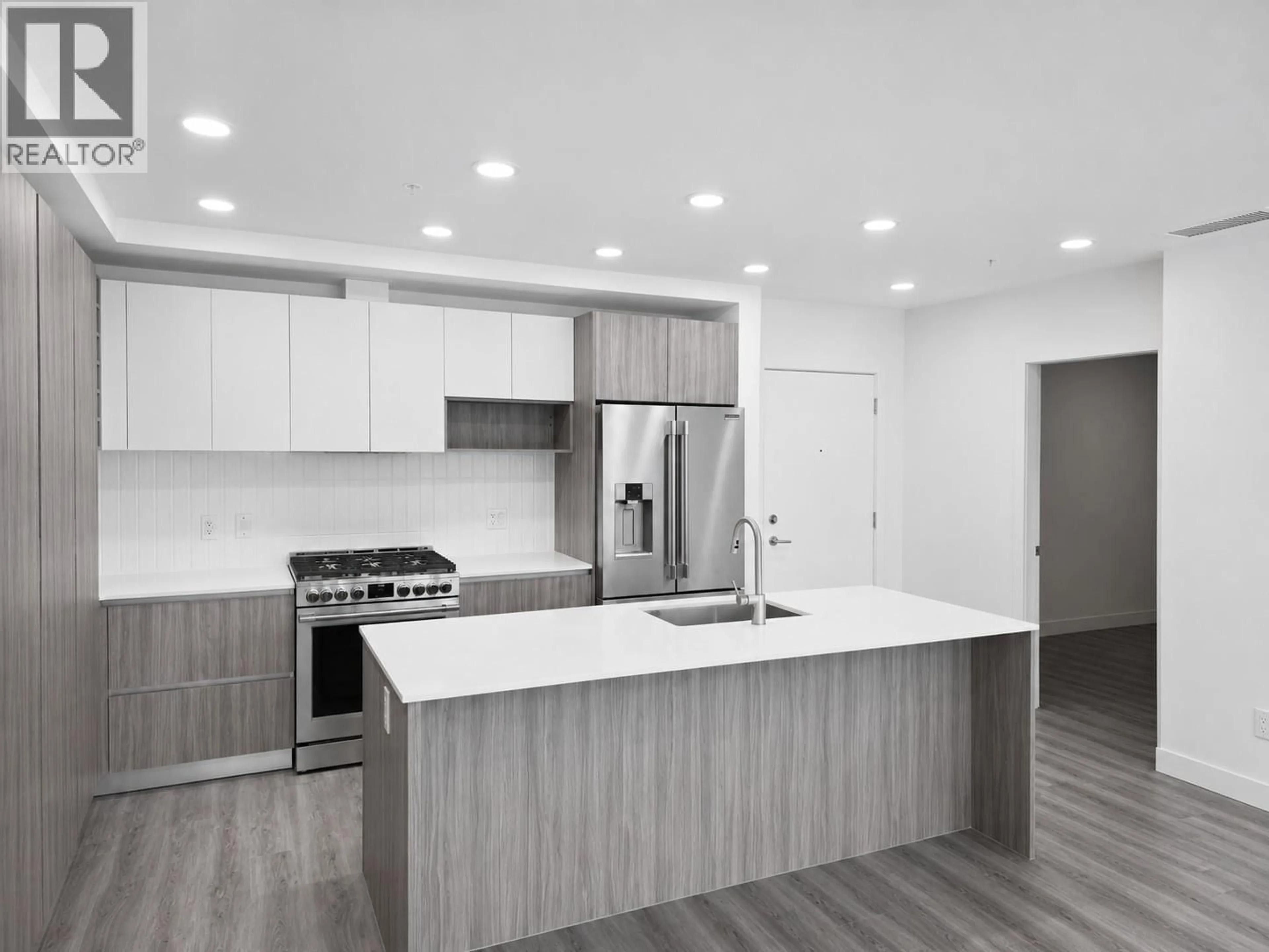 Open concept kitchen, wood/laminate floor for 204 - 2780 OLALLA ROAD, West Kelowna British Columbia V1Z2A9