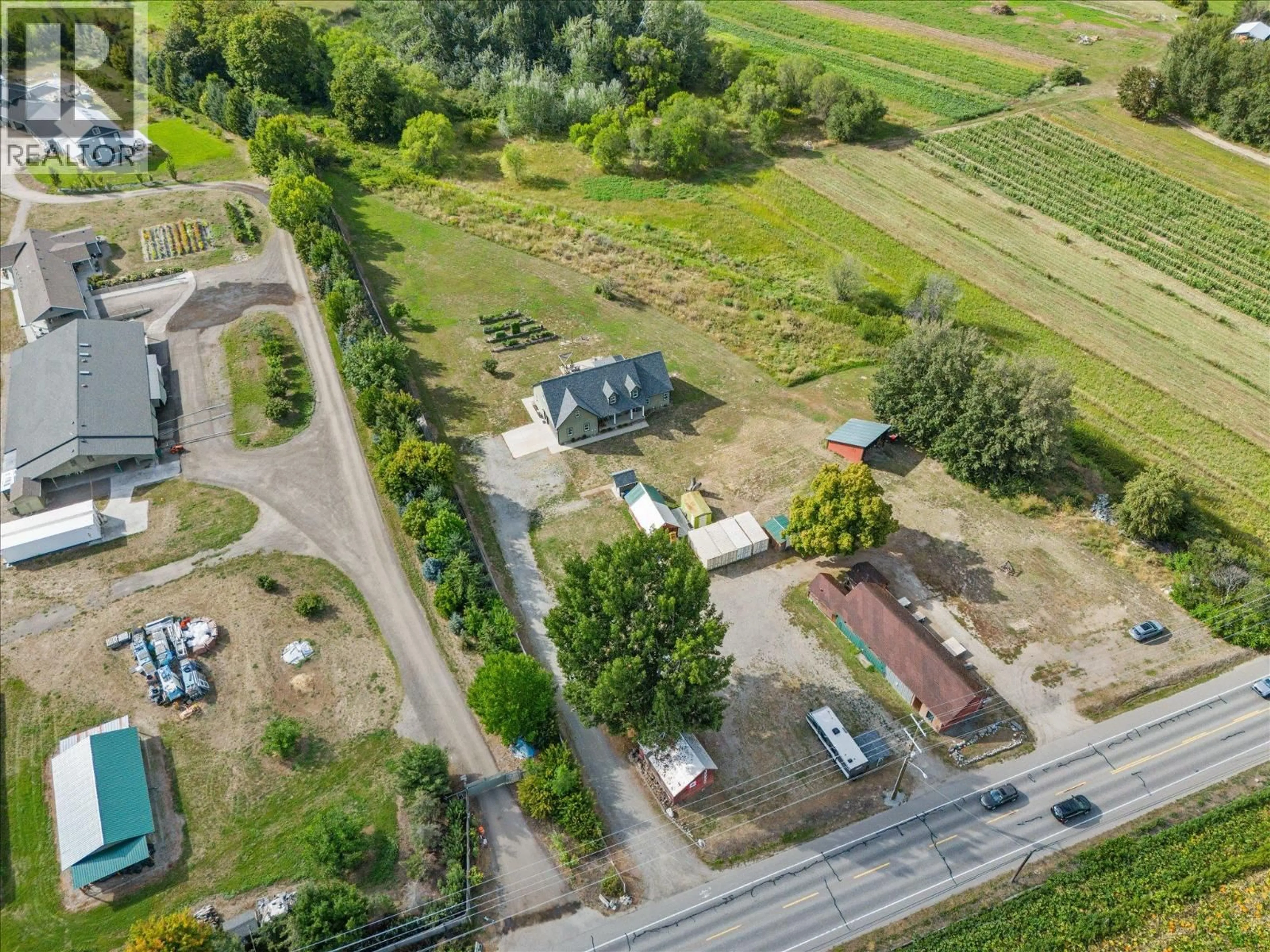 A pic from outside/outdoor area/front of a property/back of a property/a pic from drone, street for 3550 BENVOULIN ROAD, Kelowna British Columbia V1W4M6