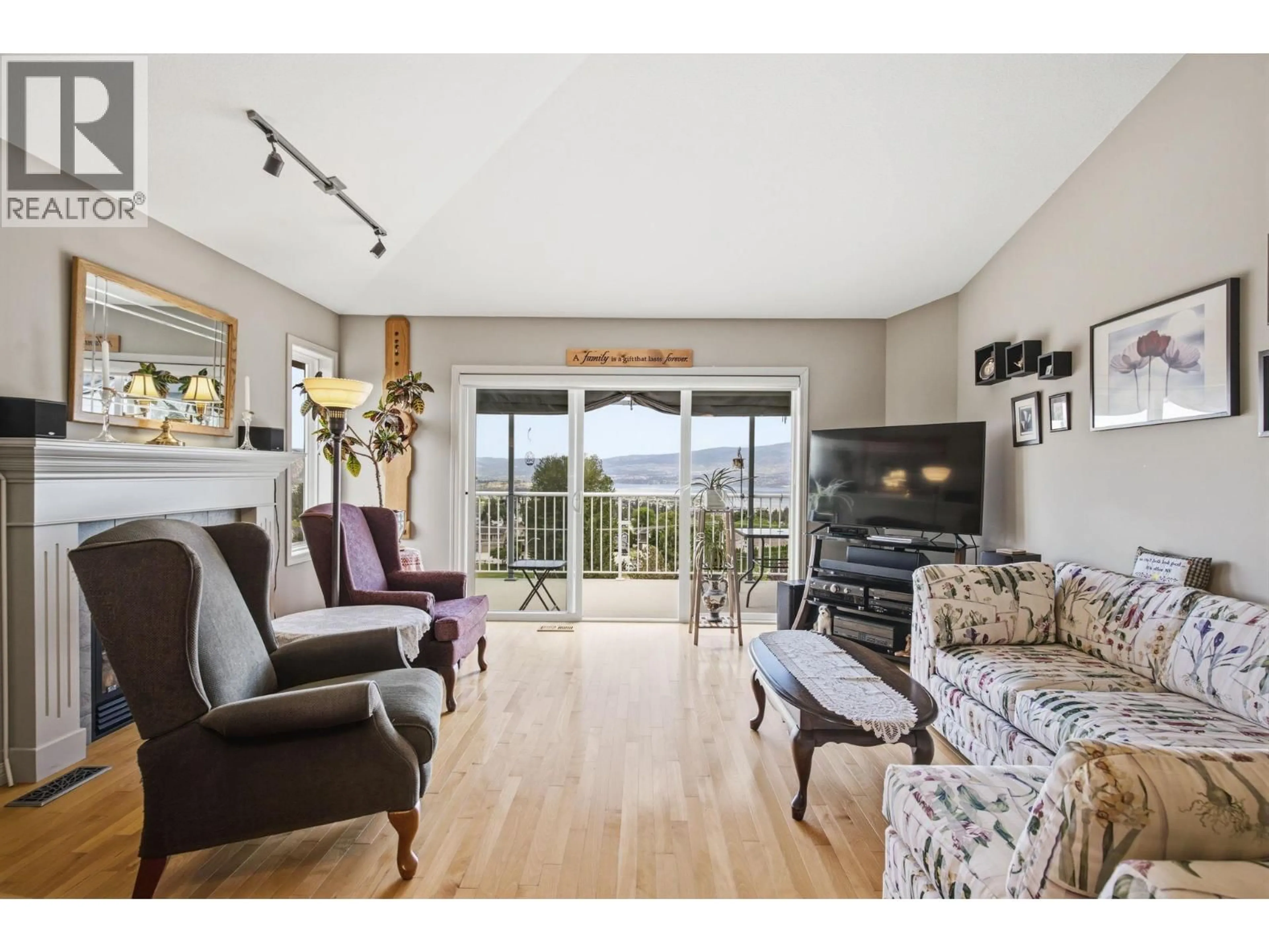 Living room with furniture, wood/laminate floor for 3652 YORKTON ROAD, West Kelowna British Columbia V4T2X2