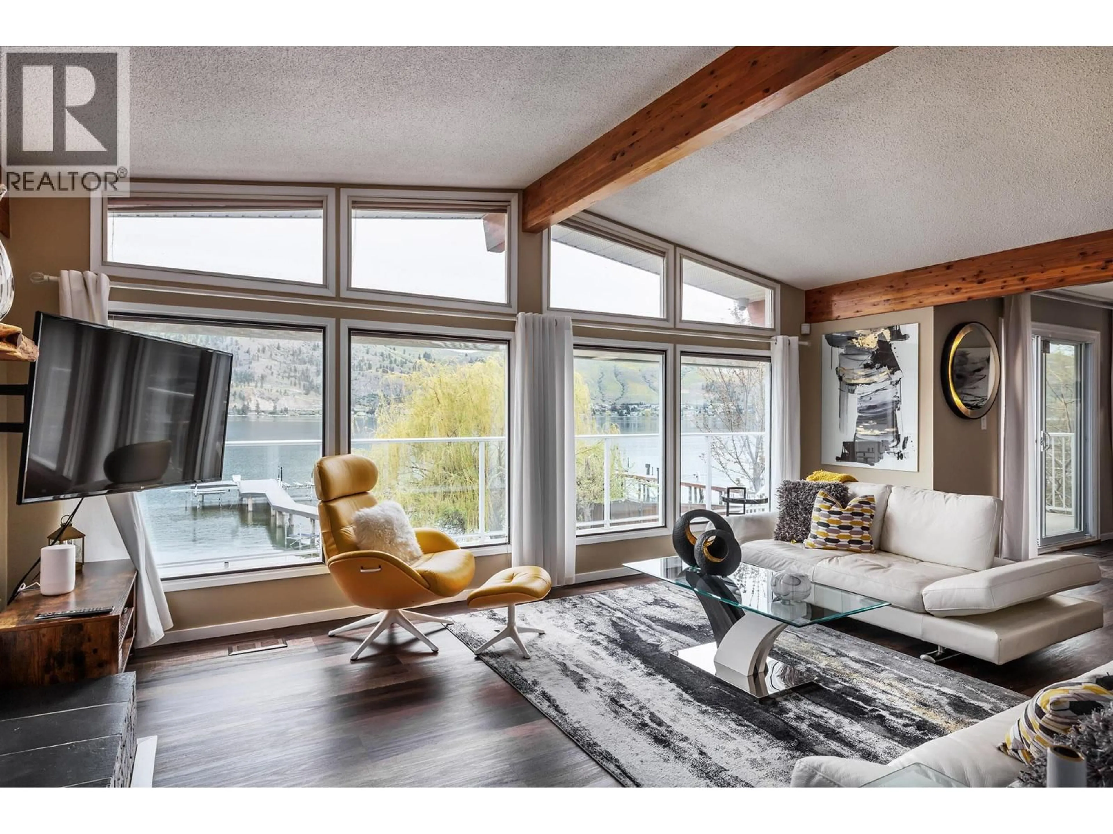 Living room with furniture, wood/laminate floor for 8291 OKANAGAN LANDING ROAD, Vernon British Columbia V1H1J5