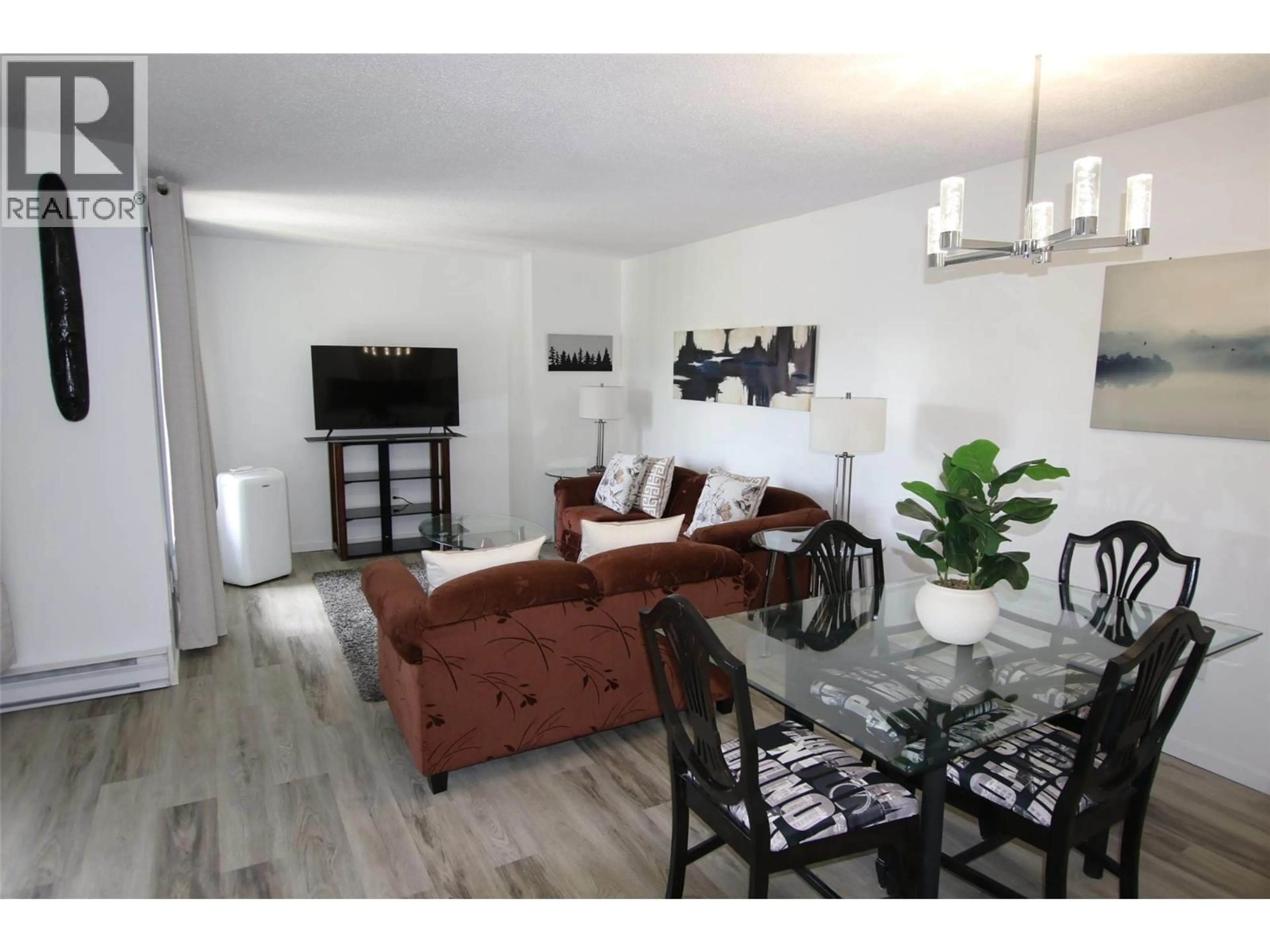 Living room with furniture, wood/laminate floor for 310 - 185 CHAMBERLAIN CRESCENT, Tumbler Ridge British Columbia V0C2W0