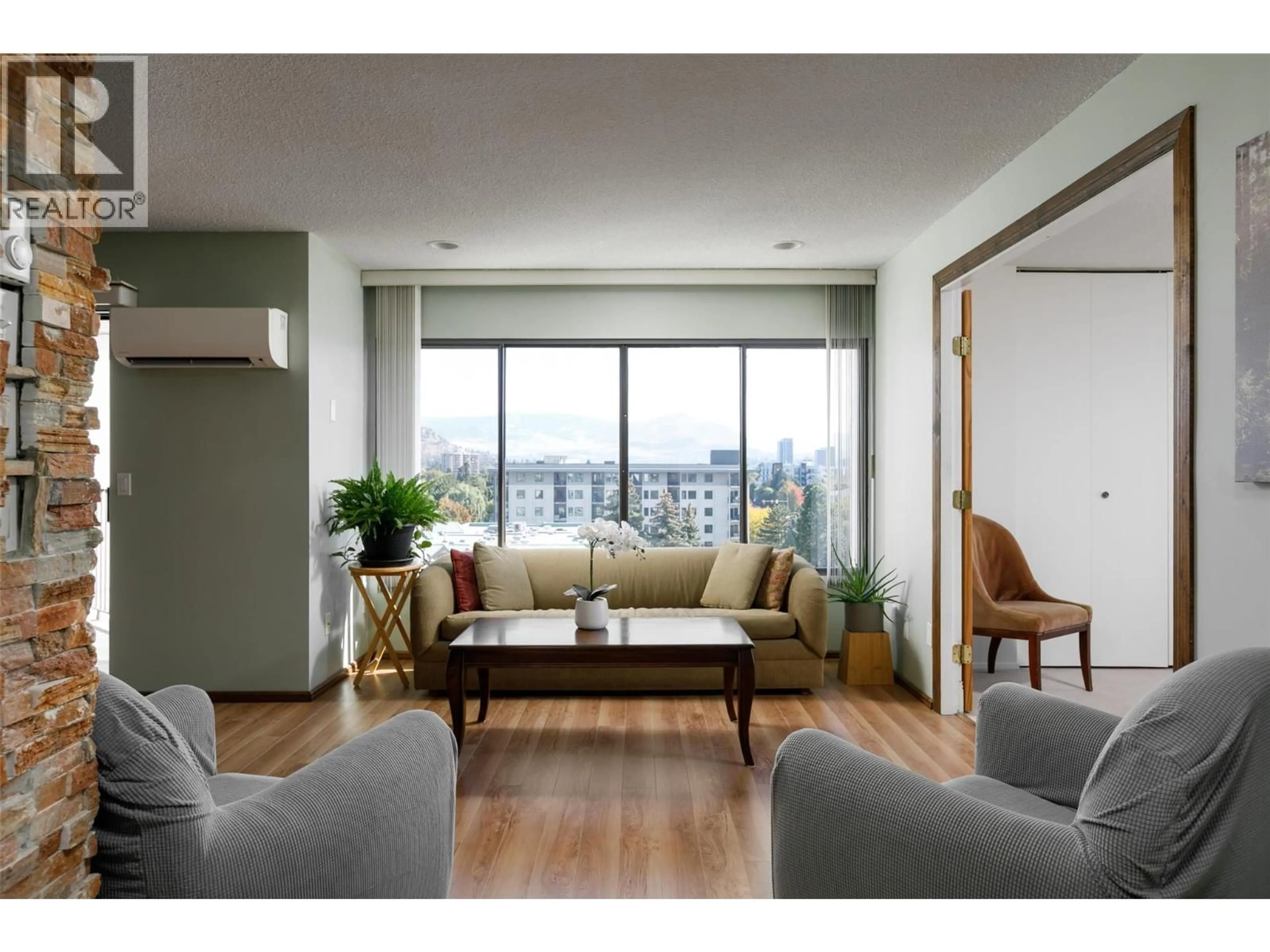 Living room with furniture, wood/laminate floor for 807 - 737 LEON AVENUE, Kelowna British Columbia V1Y8L6