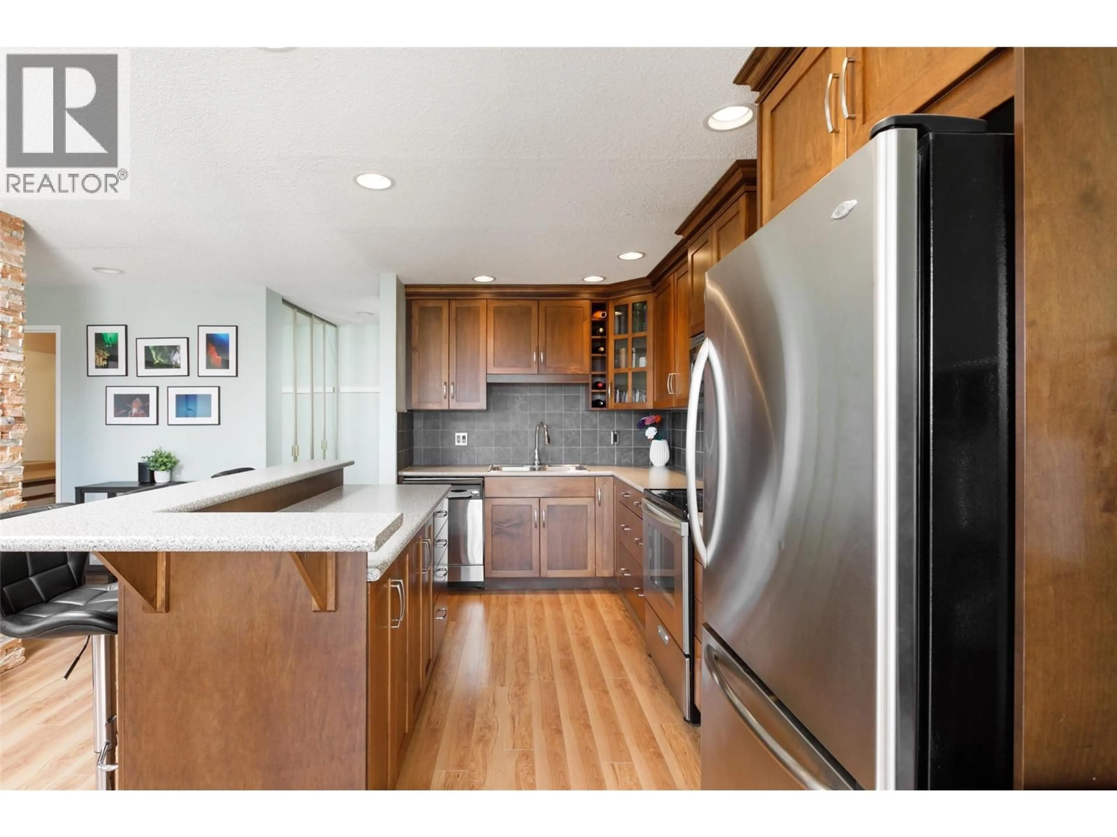Open concept kitchen, wood/laminate floor for 807 - 737 LEON AVENUE, Kelowna British Columbia V1Y8L6