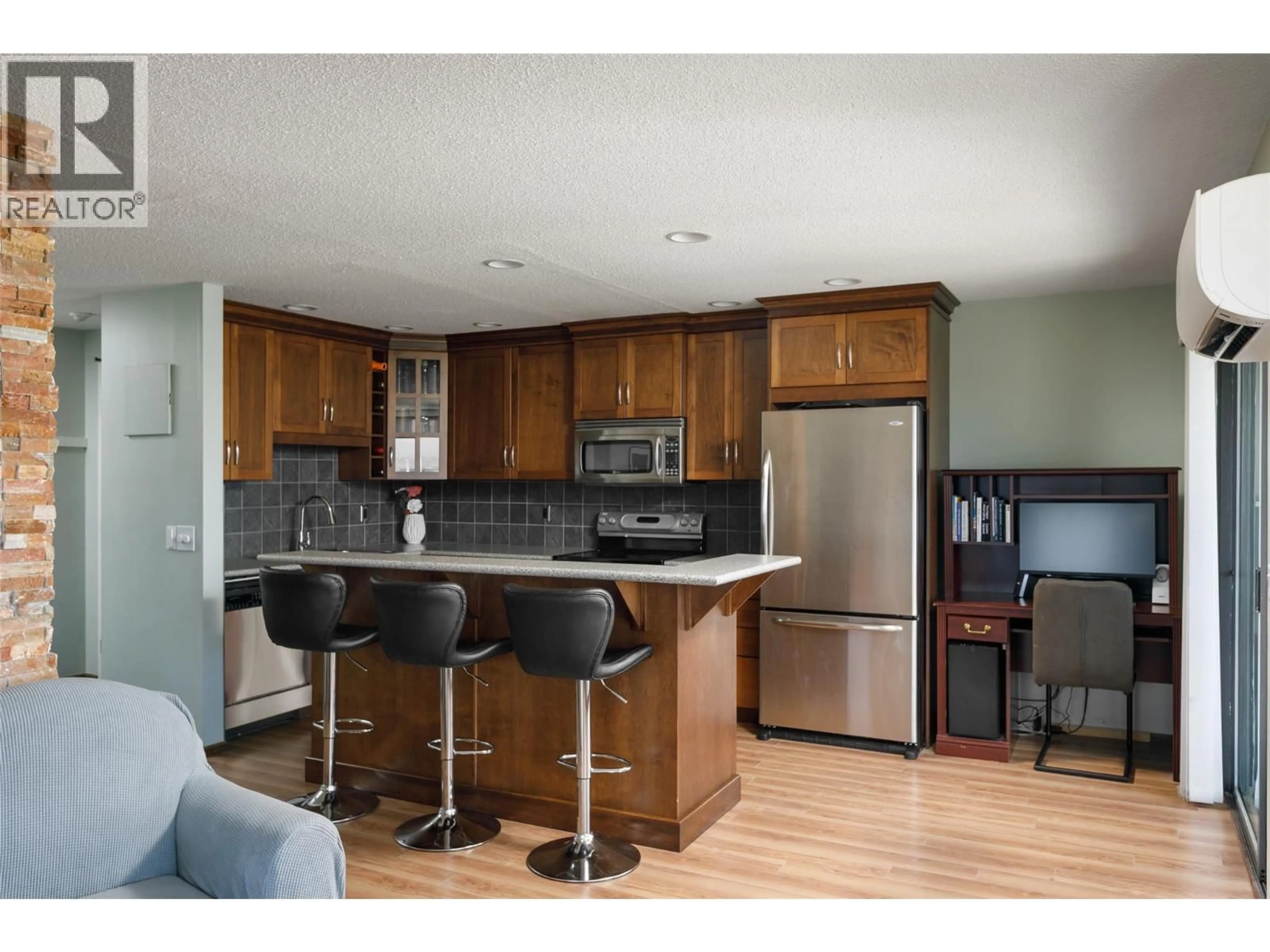 Open concept kitchen, wood/laminate floor for 807 - 737 LEON AVENUE, Kelowna British Columbia V1Y8L6