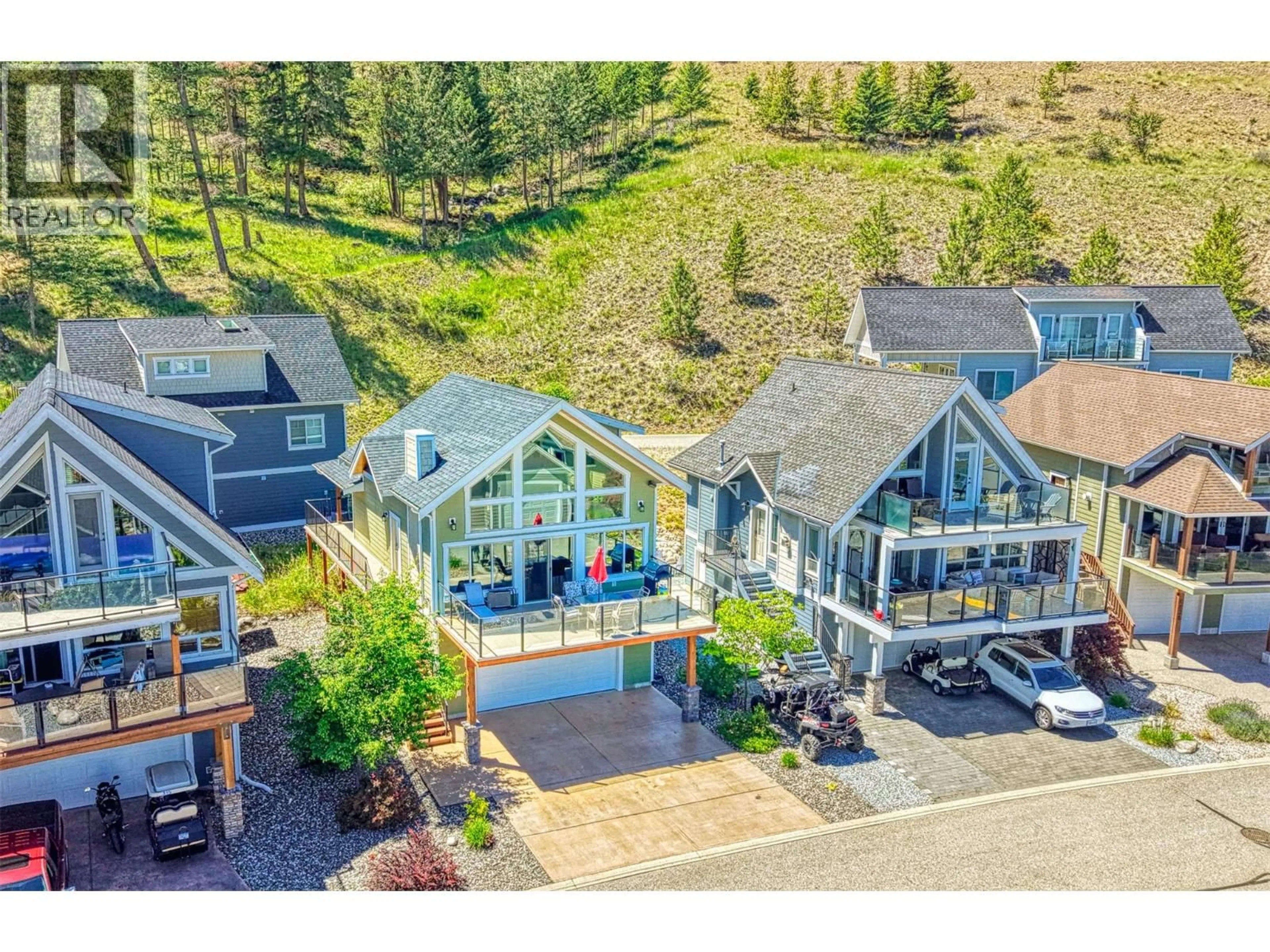 A pic from outside/outdoor area/front of a property/back of a property/a pic from drone, mountain view for 316 - 6834 MADRID WAY, Kelowna British Columbia V1Z3R8