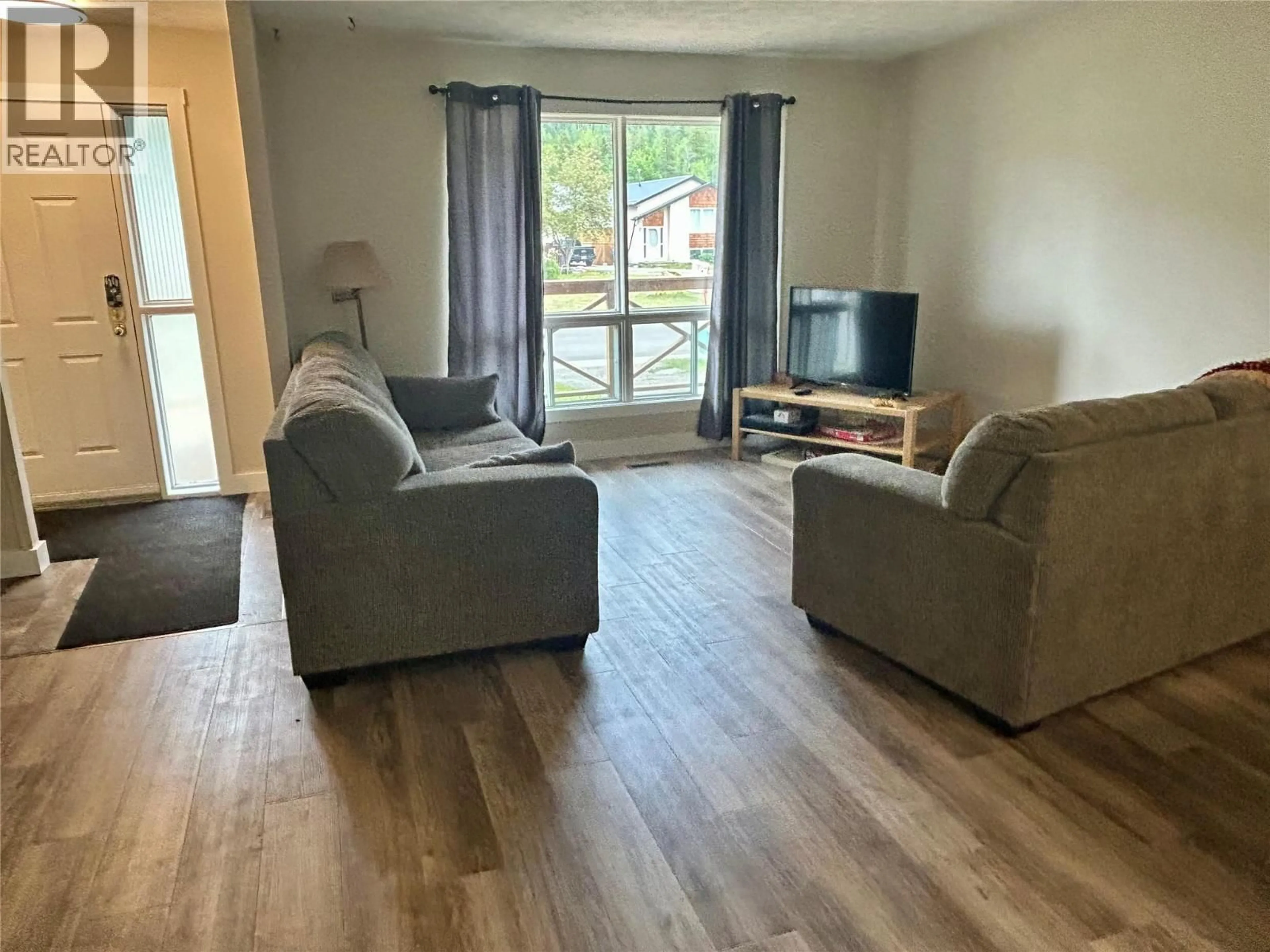 Living room with furniture, wood/laminate floor for 139 WOLVERINE AVENUE, Tumbler Ridge British Columbia V0C2W0