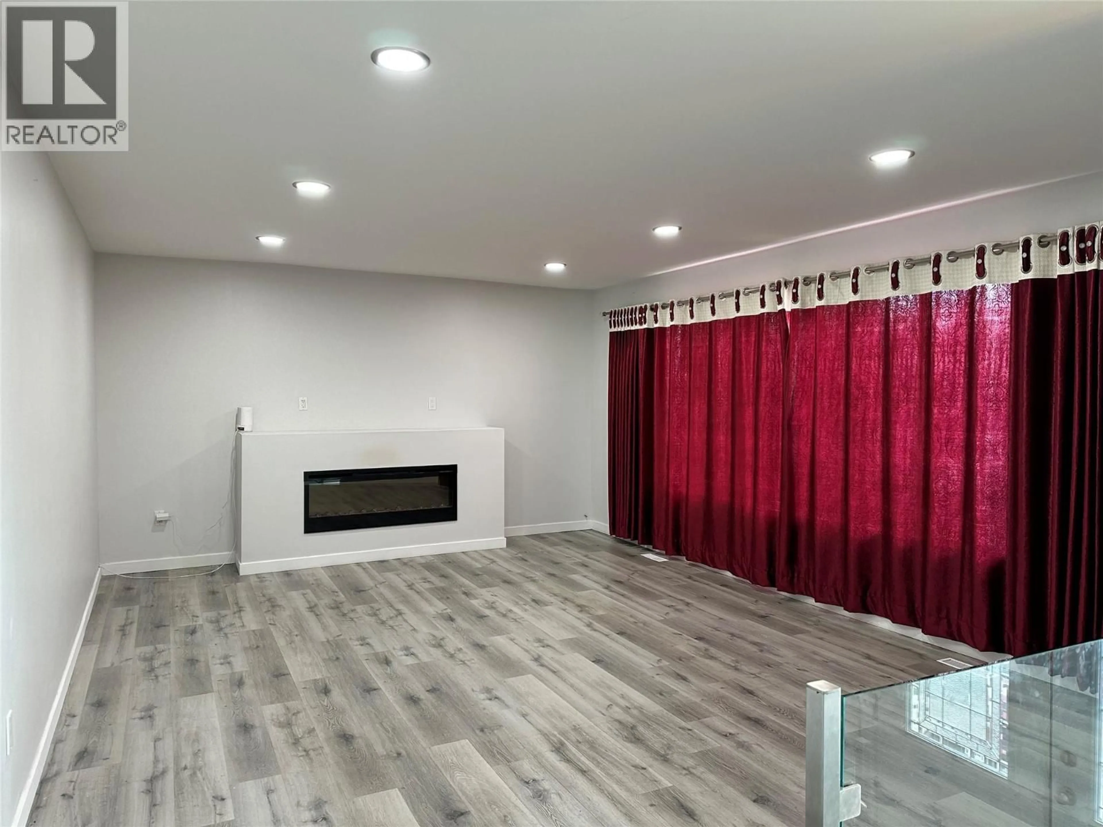 Living room with furniture, wood/laminate floor for 3802 21 AVENUE, Vernon British Columbia V1T6P8