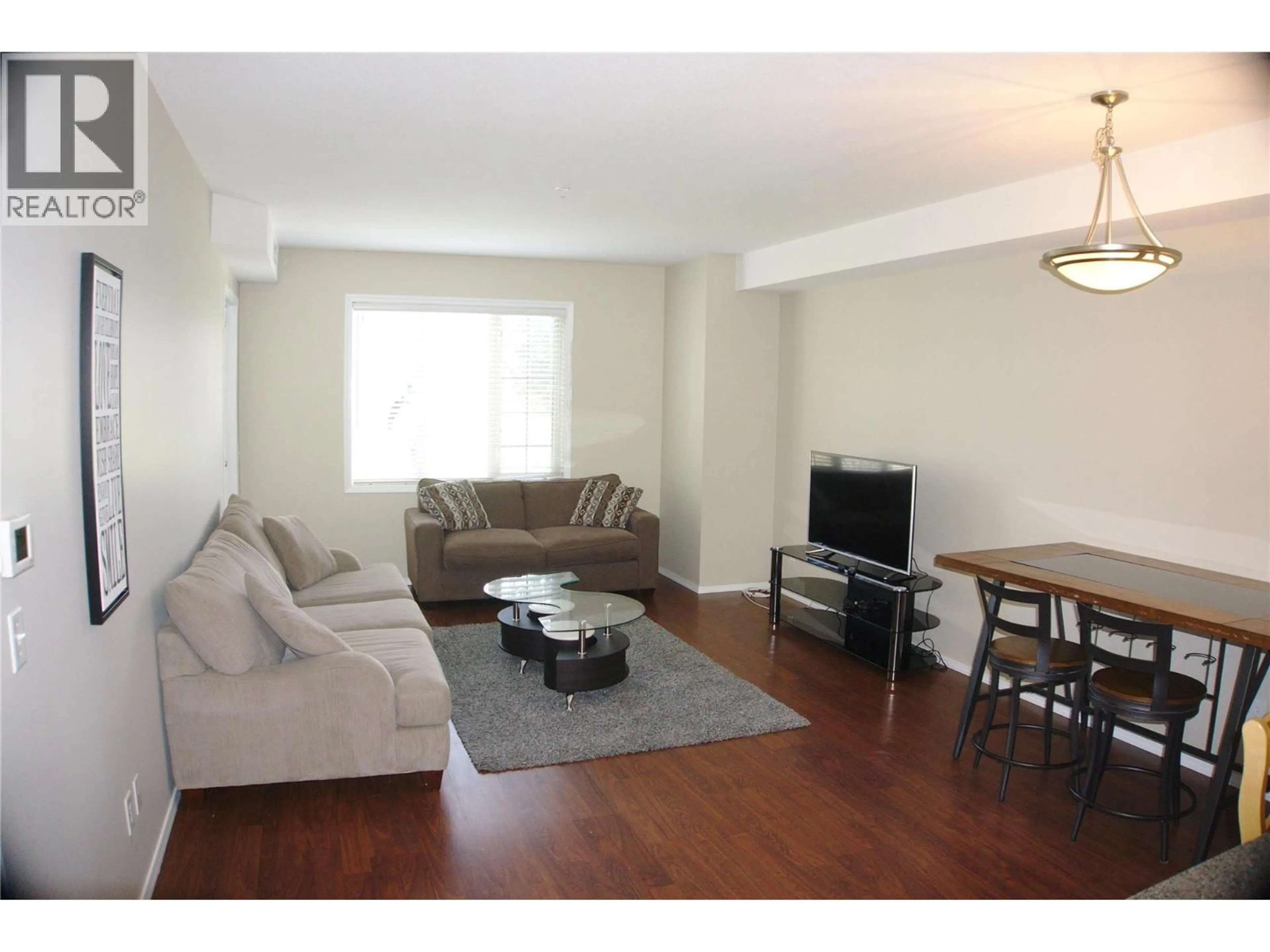 Living room with furniture, wood/laminate floor for 1316 - 1875 COUNTRY CLUB DRIVE, Kelowna British Columbia V1V2W7