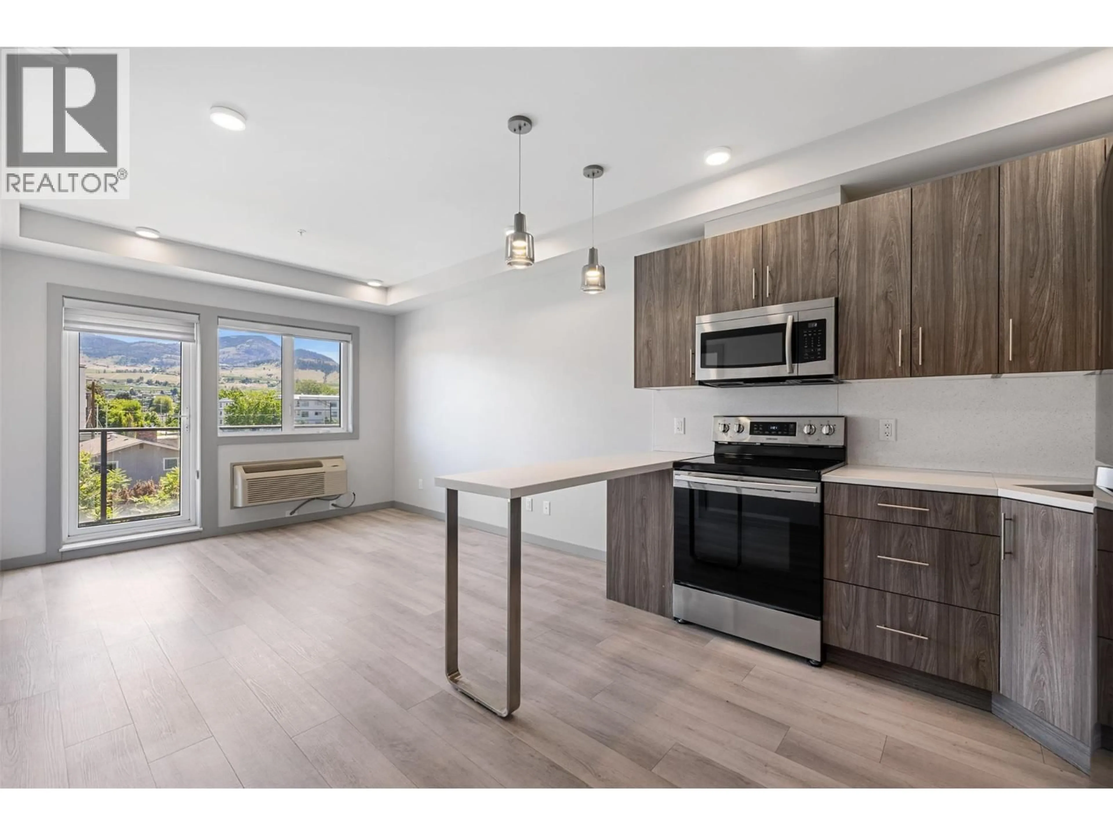 Open concept kitchen, wood/laminate floor for 325 - 345 DOUGALL ROAD, Kelowna British Columbia V1X0A8
