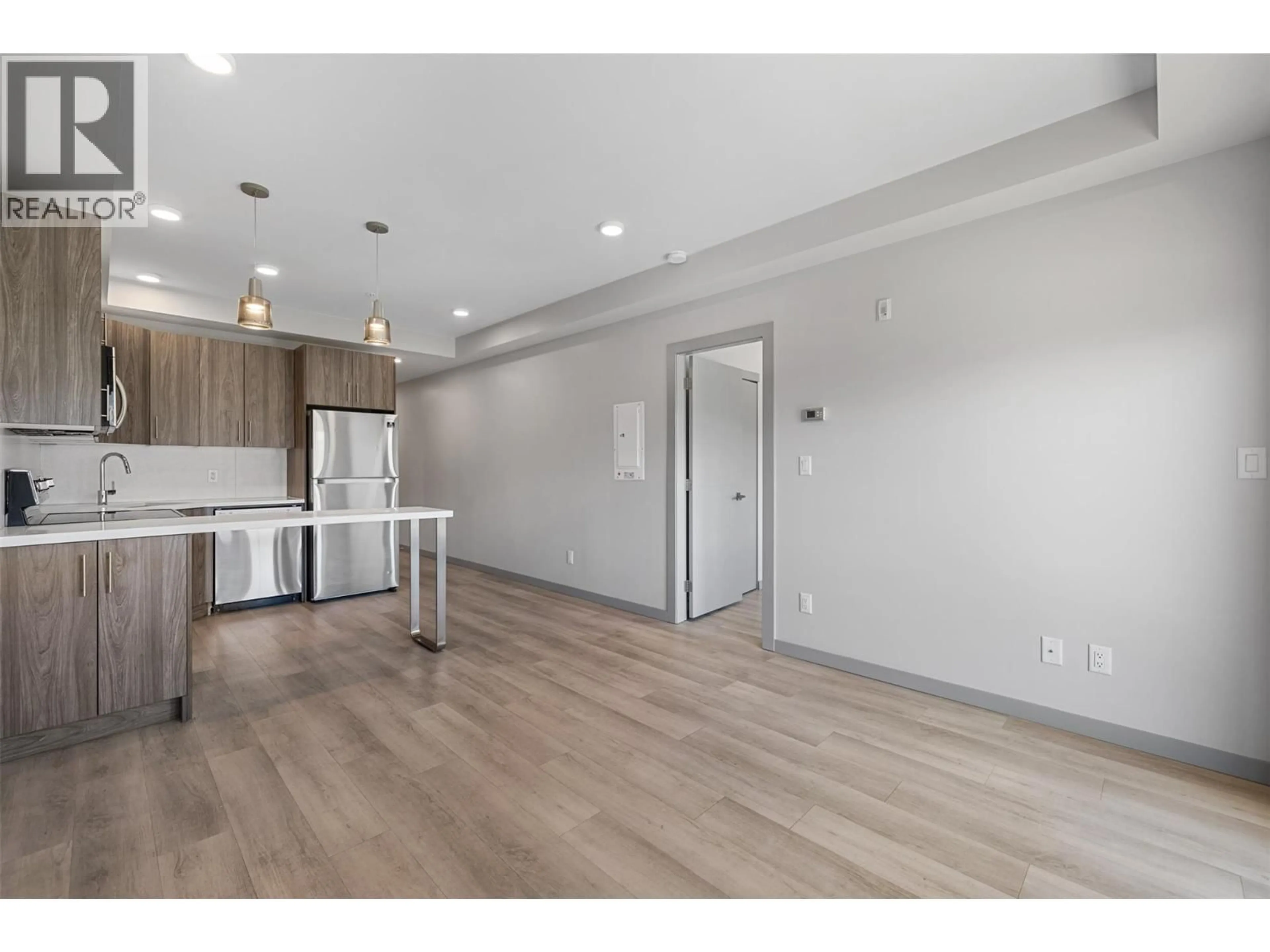 Open concept kitchen, wood/laminate floor for 325 - 345 DOUGALL ROAD, Kelowna British Columbia V1X0A8