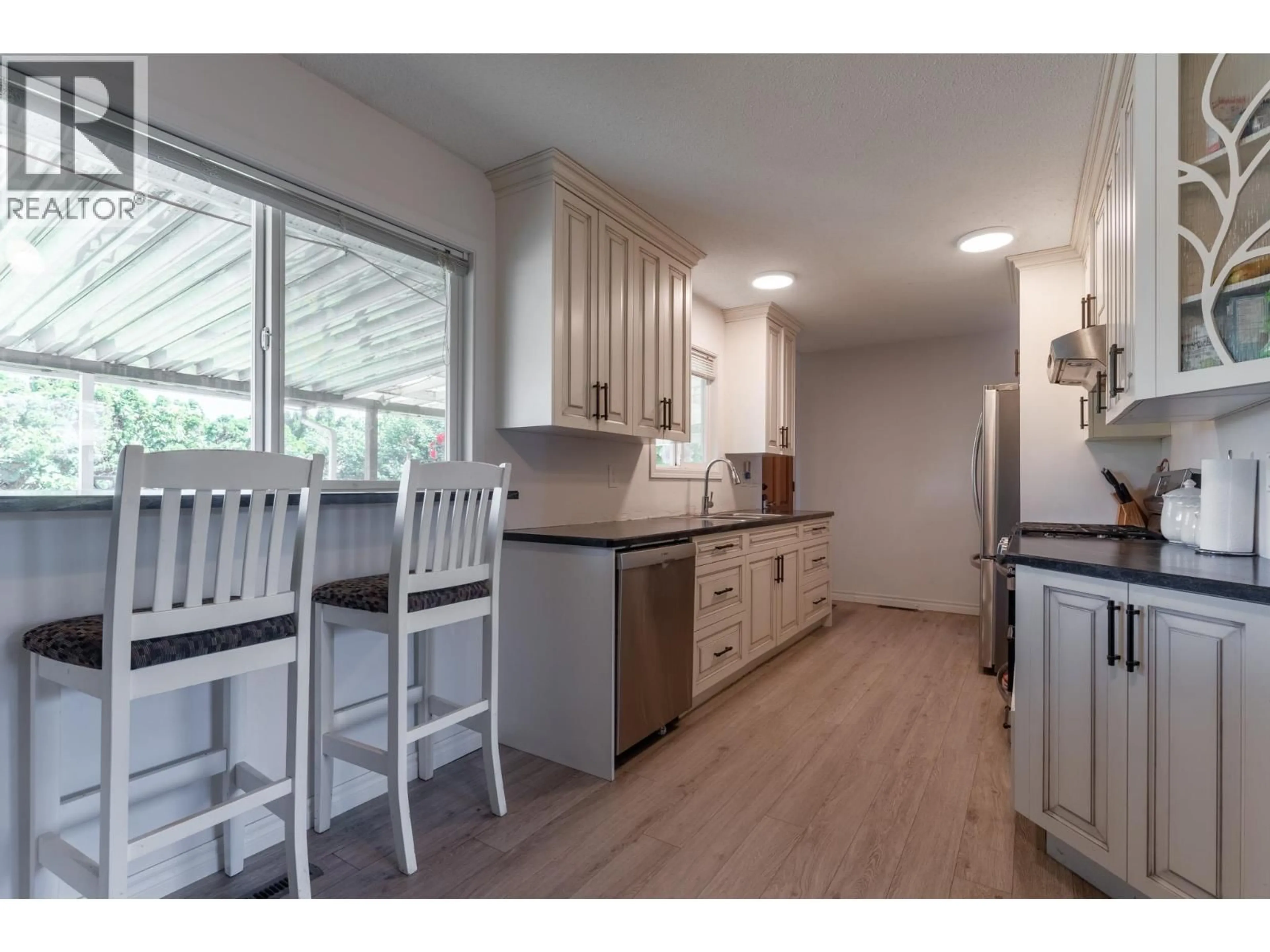 Open concept kitchen, wood/laminate floor for 500 MALLACH ROAD, Kelowna British Columbia V1X2W8