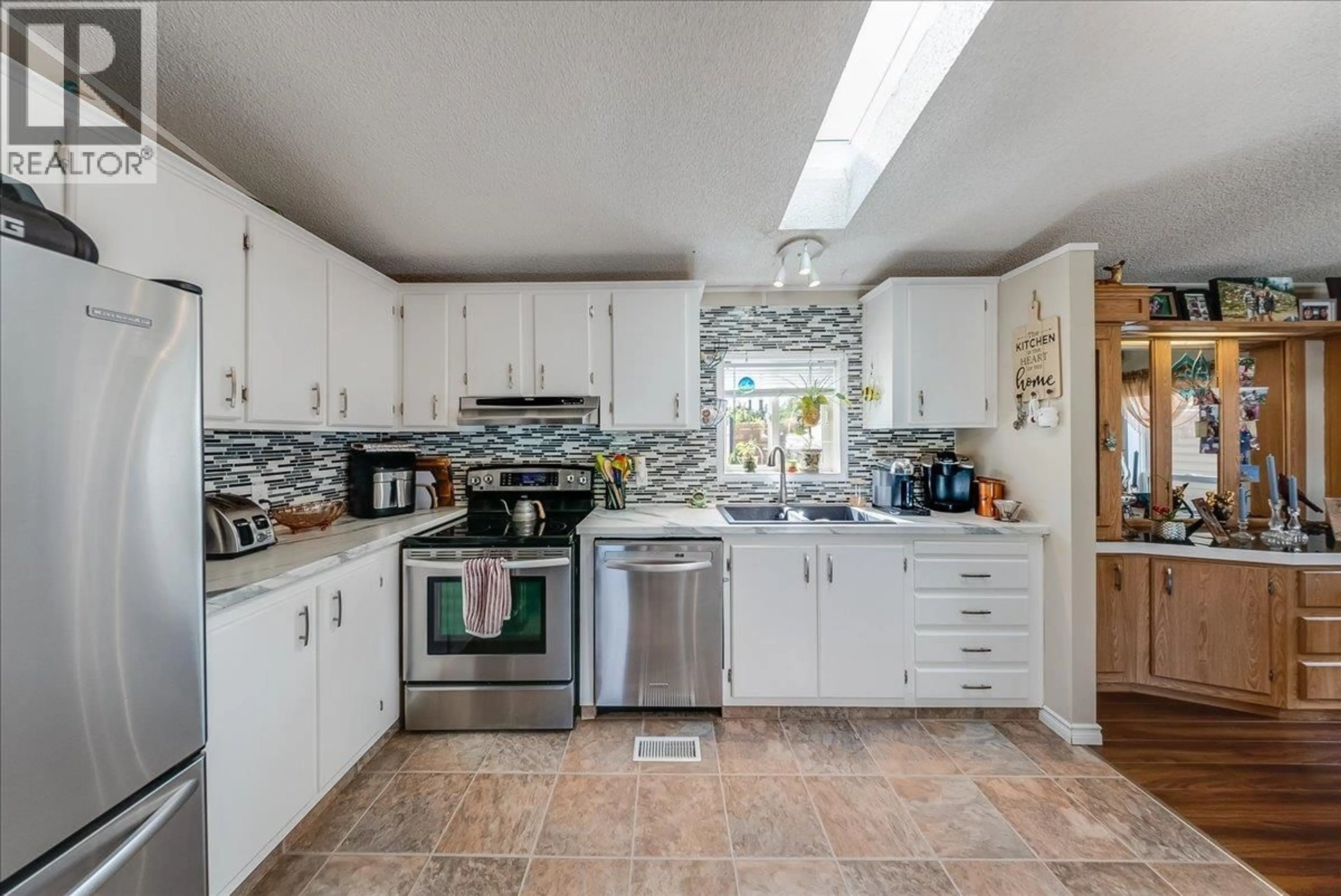 Open concept kitchen, ceramic/tile floor for 1026 HORCOFF ROAD, Robson British Columbia V1N4V1