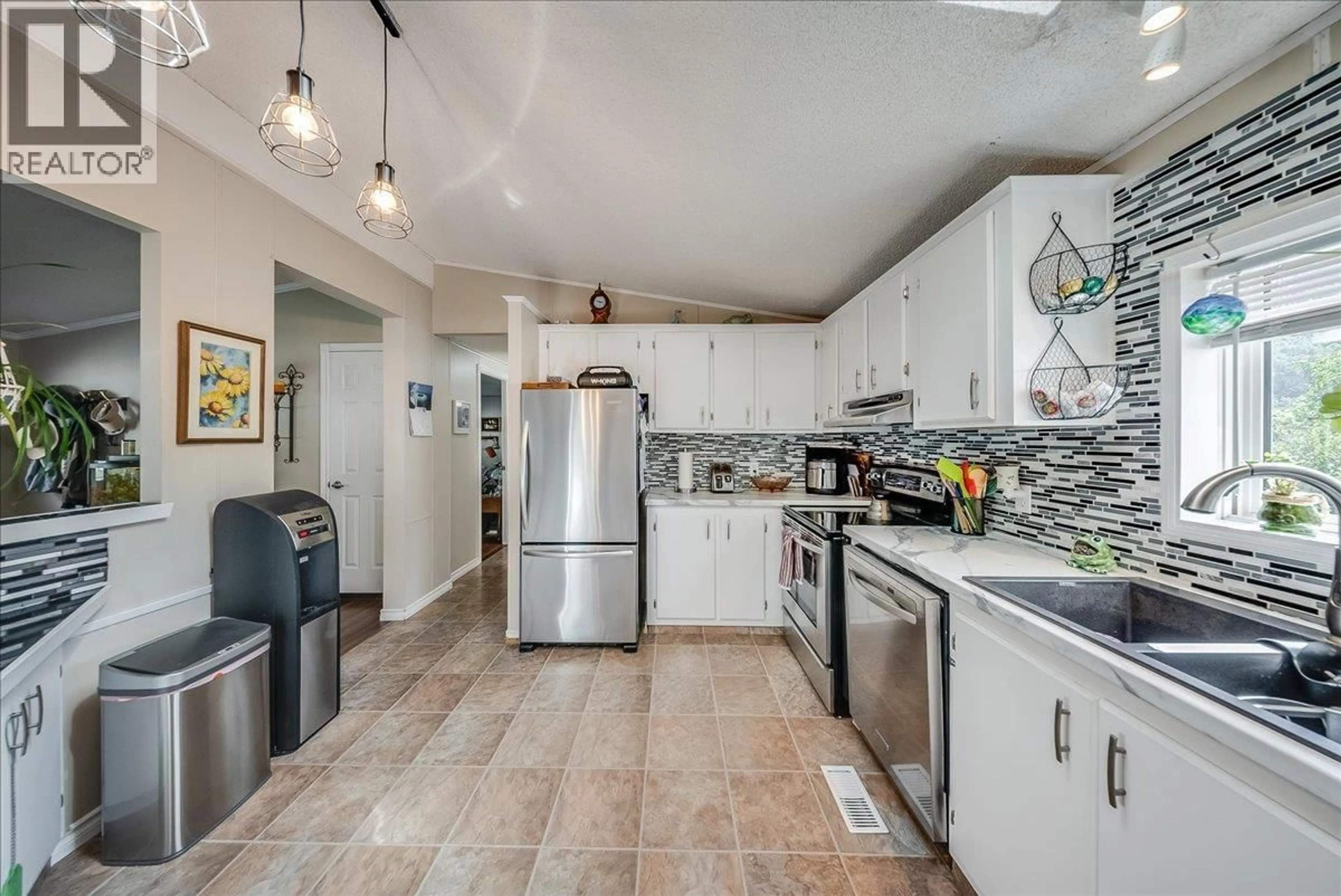 Open concept kitchen, ceramic/tile floor for 1026 HORCOFF ROAD, Robson British Columbia V1N4V1