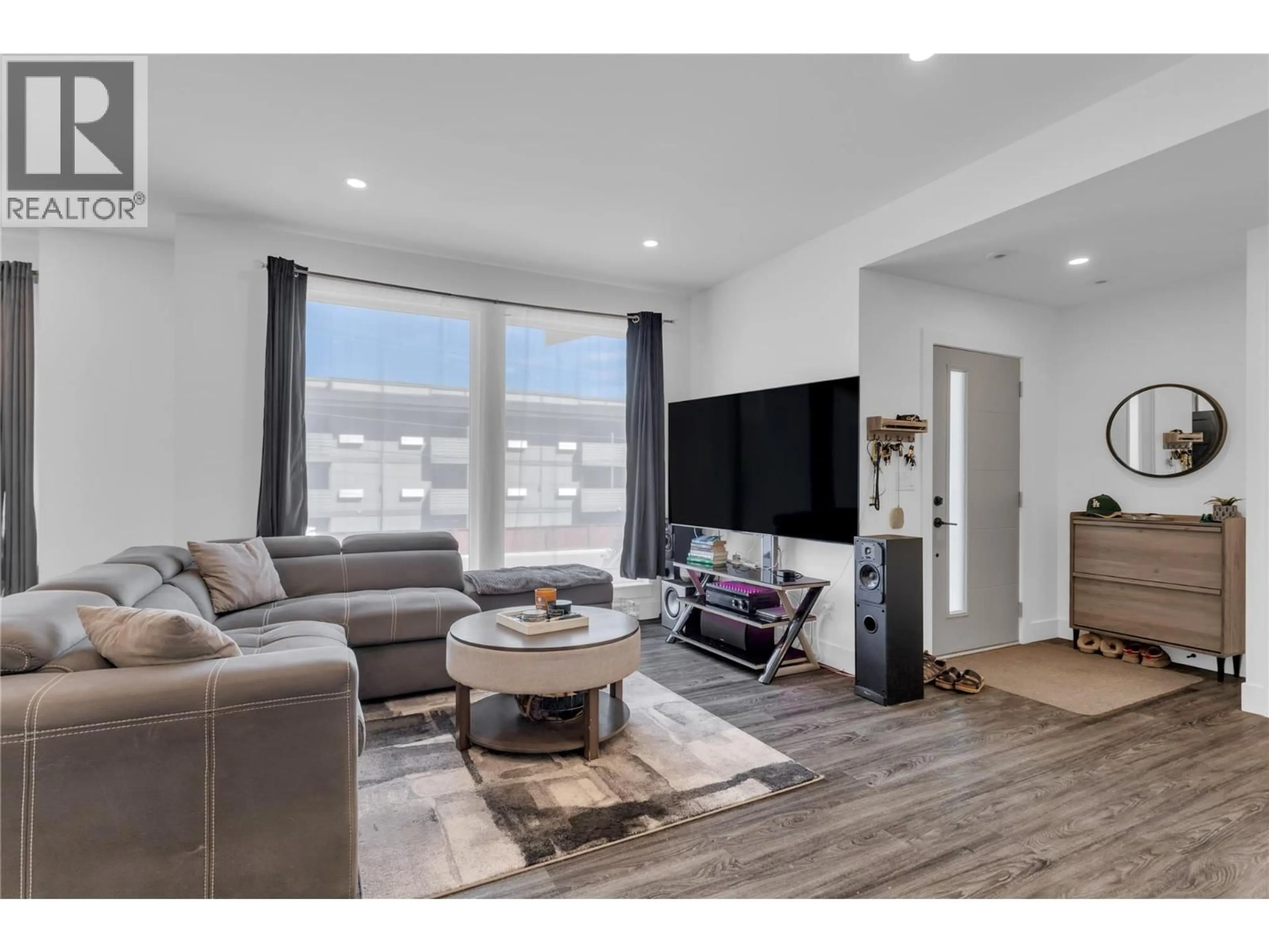 Living room with furniture, wood/laminate floor for 4214 33 STREET, Vernon British Columbia V1T5V1