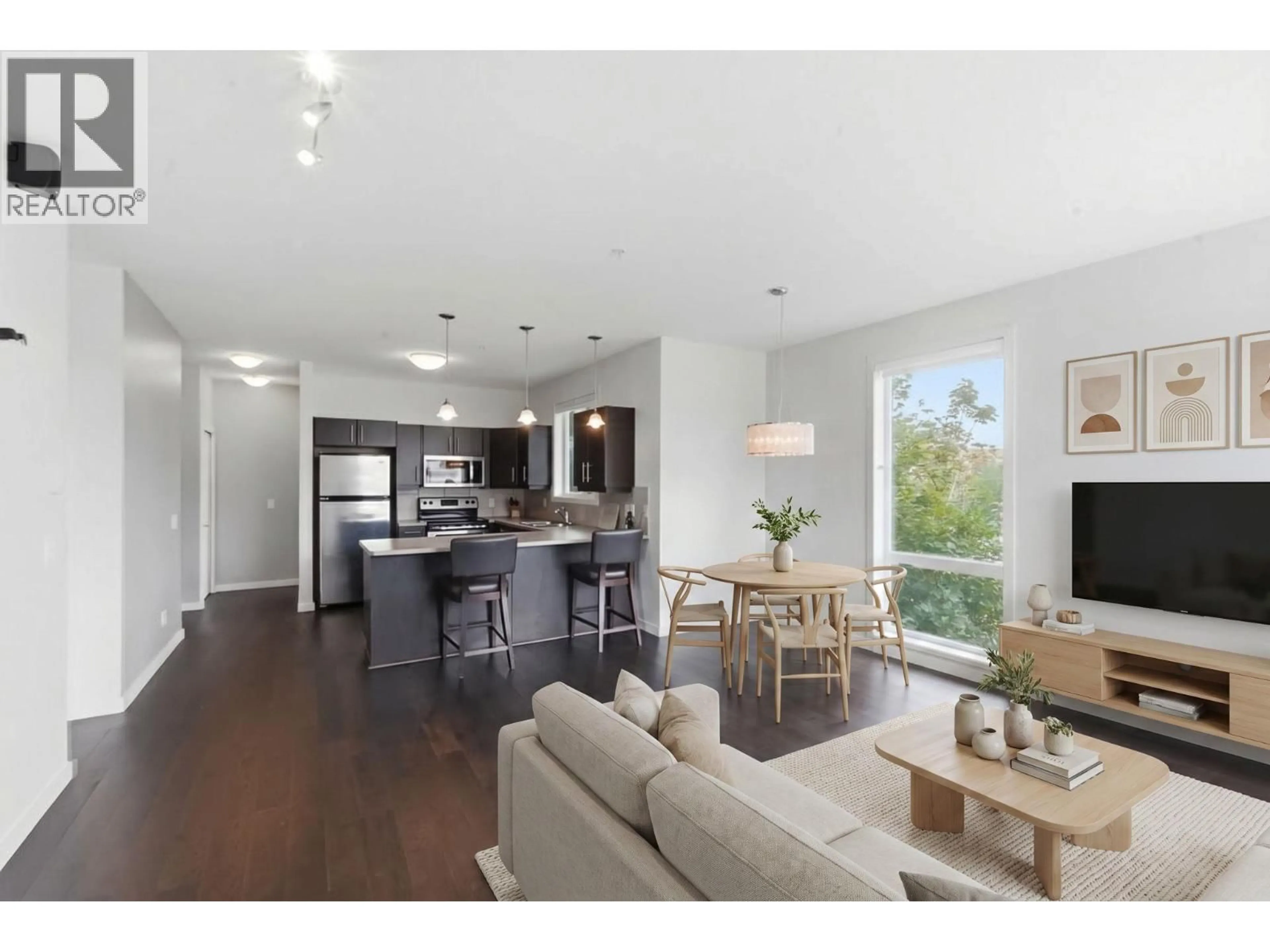 Open concept kitchen, wood/laminate floor for 306 - 130 BARBER ROAD, Kelowna British Columbia V1X3V4