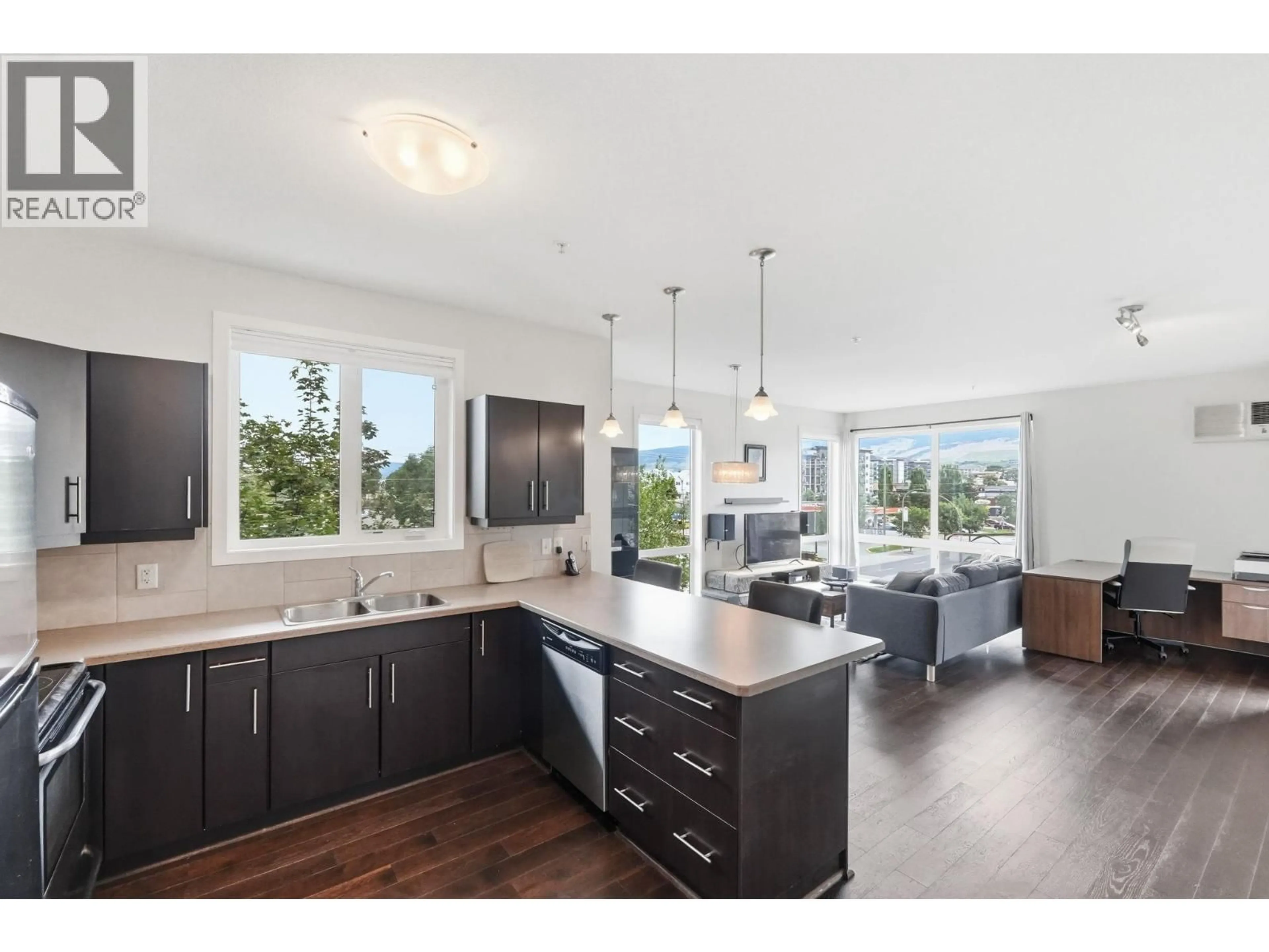 Open concept kitchen, wood/laminate floor for 306 - 130 BARBER ROAD, Kelowna British Columbia V1X3V4