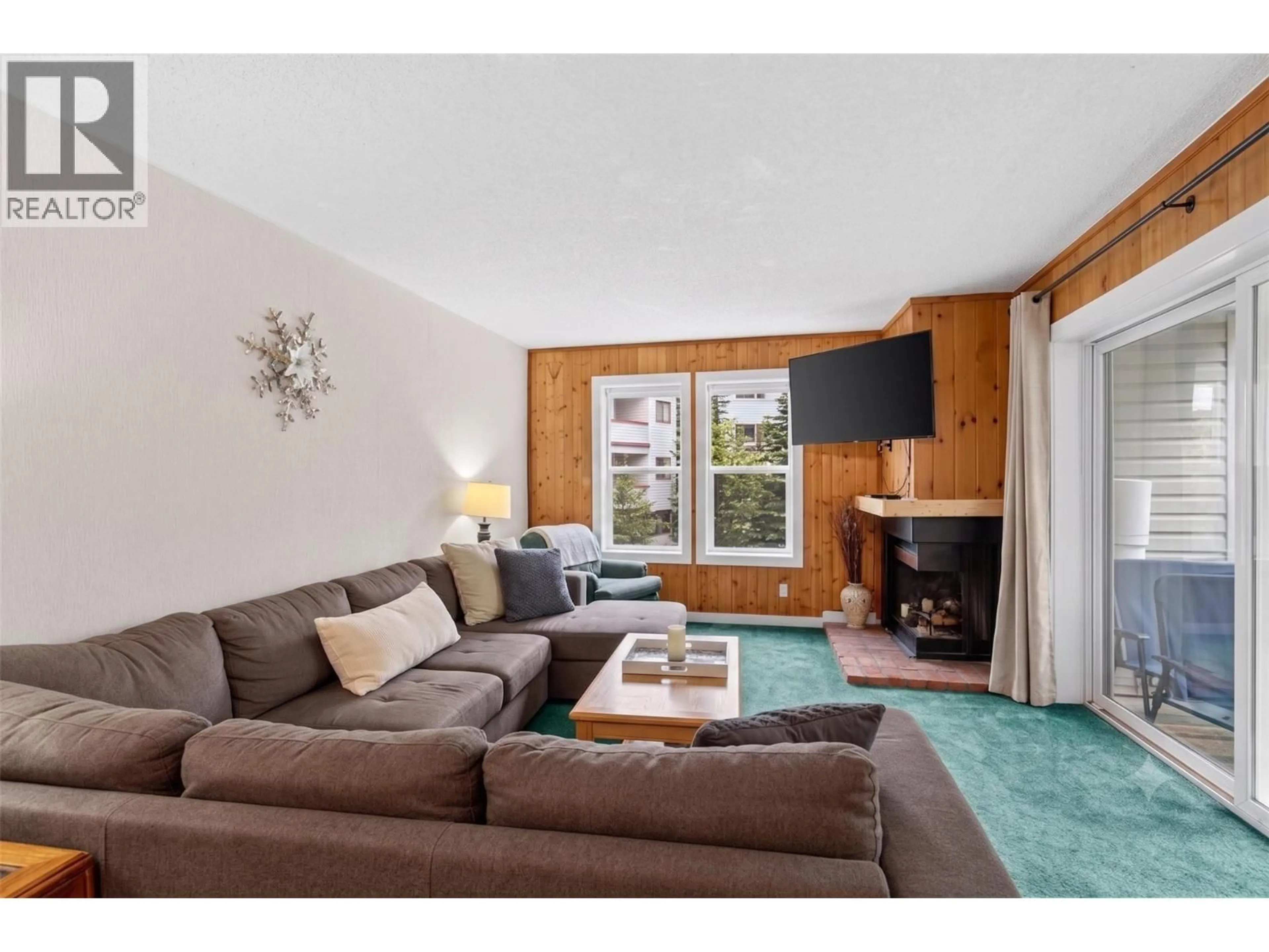 Living room with furniture, wood/laminate floor for 210 - 60 WOLVERINE ROAD, Big White British Columbia V1P1P3