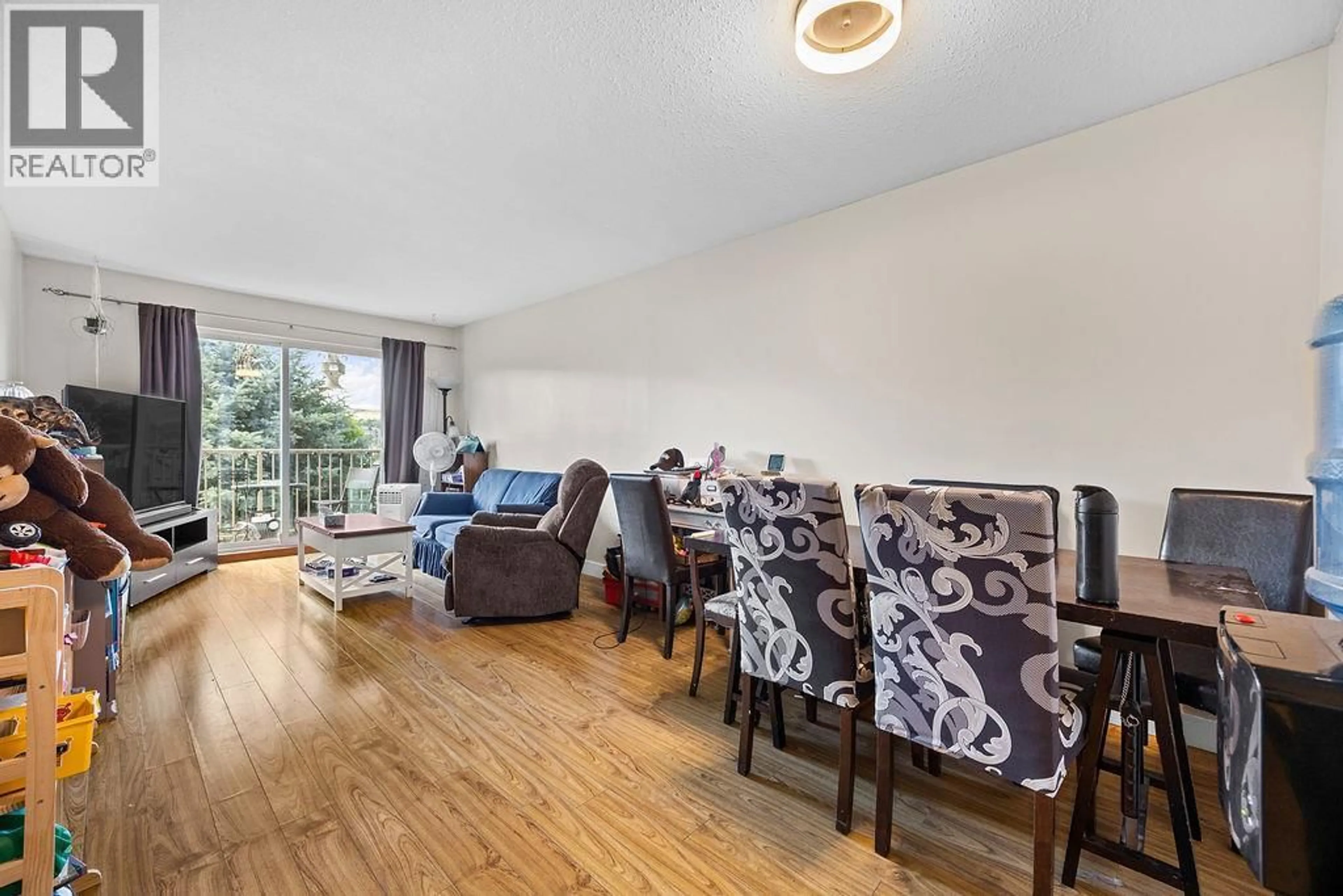 Living room with furniture, wood/laminate floor for 305 - 3304 35TH AVENUE, Vernon British Columbia V1T8M6