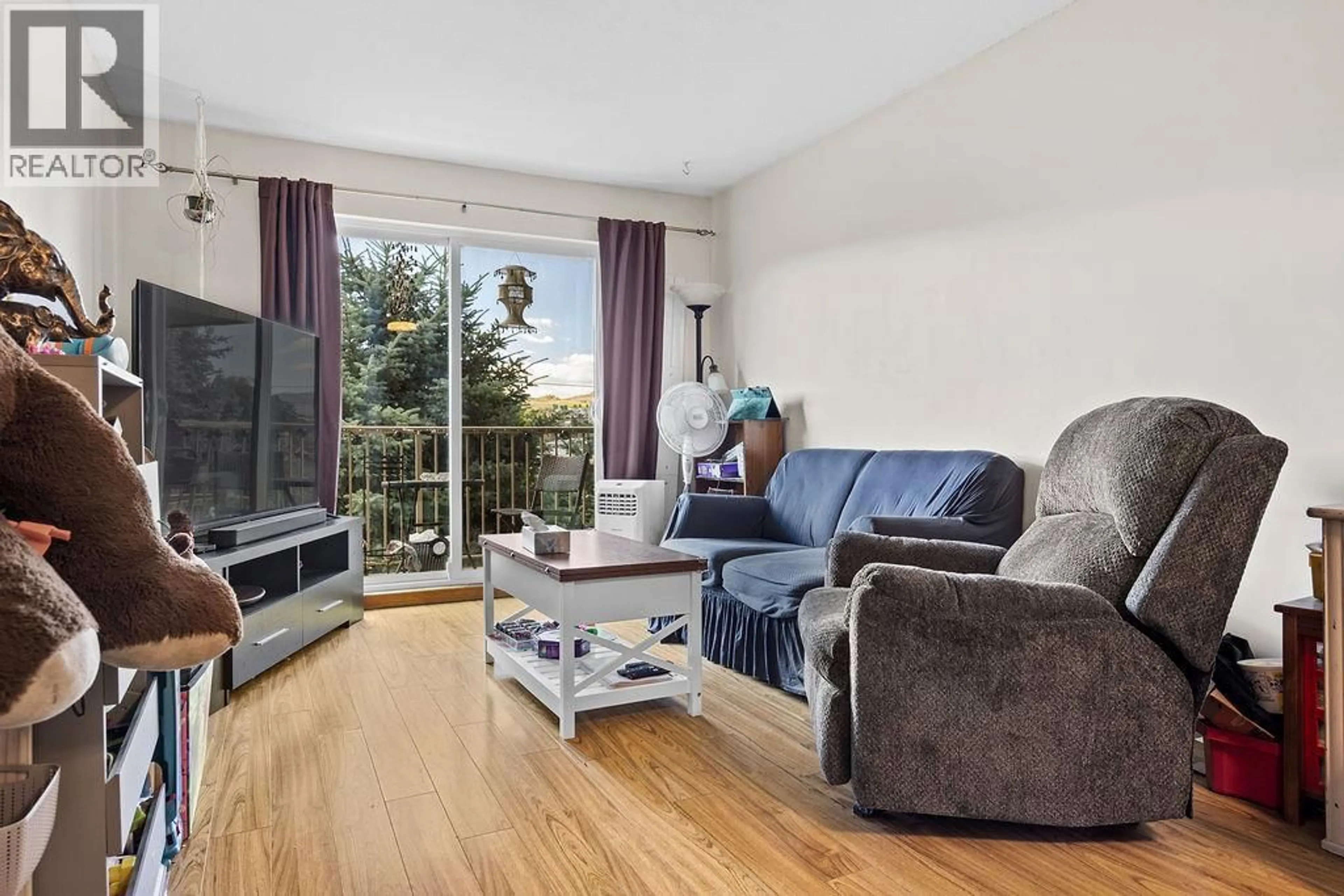 Living room with furniture, wood/laminate floor for 305 - 3304 35TH AVENUE, Vernon British Columbia V1T8M6