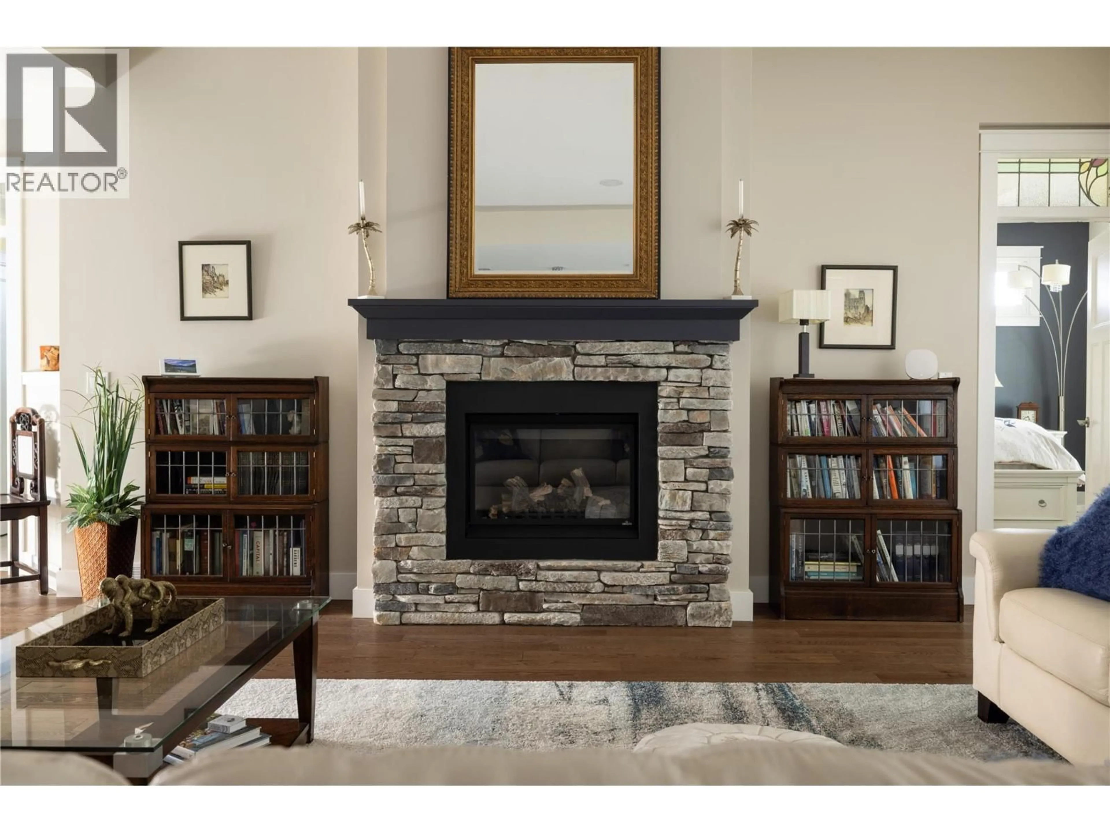 Living room with furniture, wood/laminate floor for 579 LONGSPOON COURT, Vernon British Columbia V1H2K2