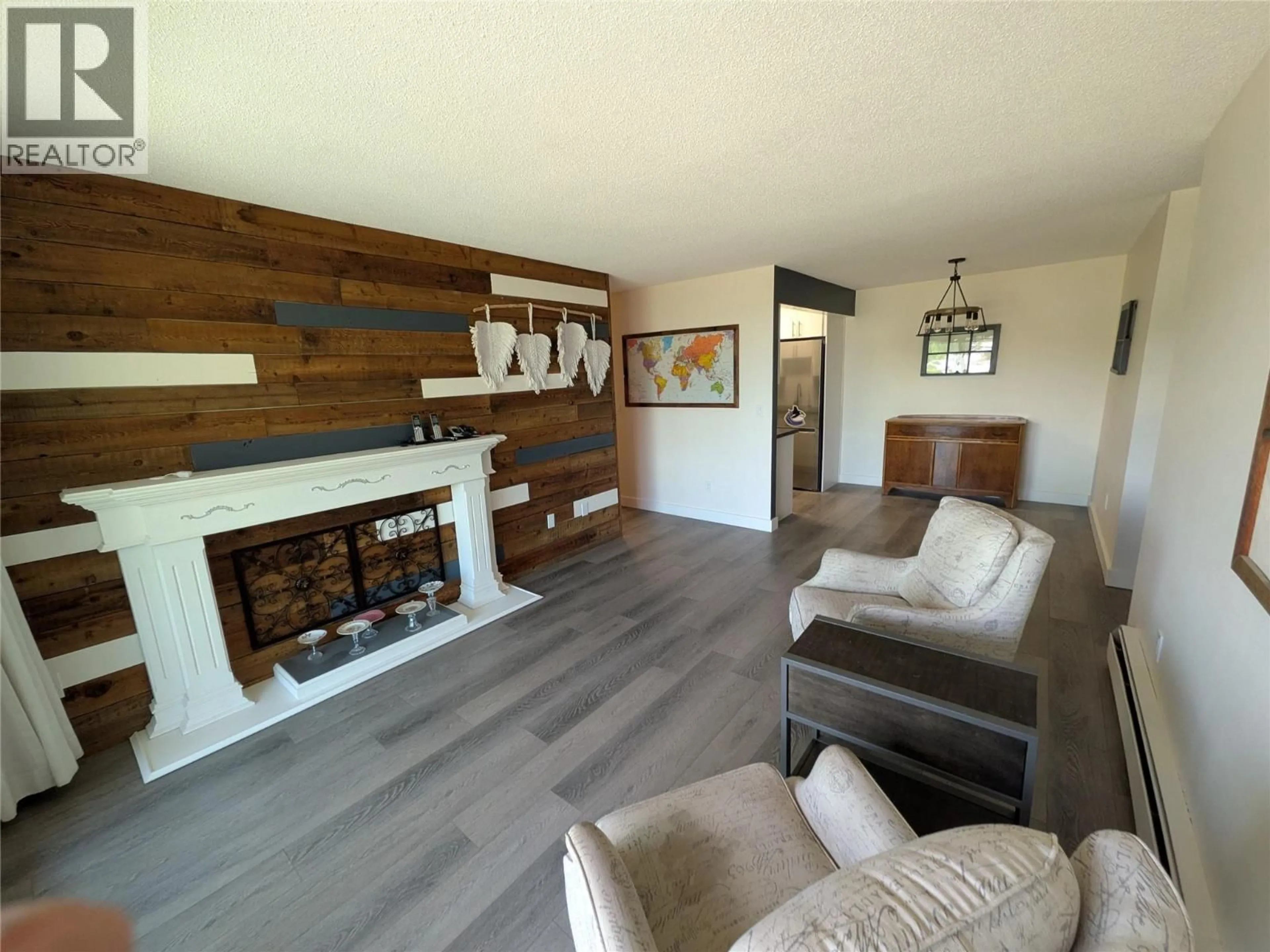 Living room with furniture, wood/laminate floor for 306 - 308 CHARTRAND AVENUE, Logan Lake British Columbia V0K1W0