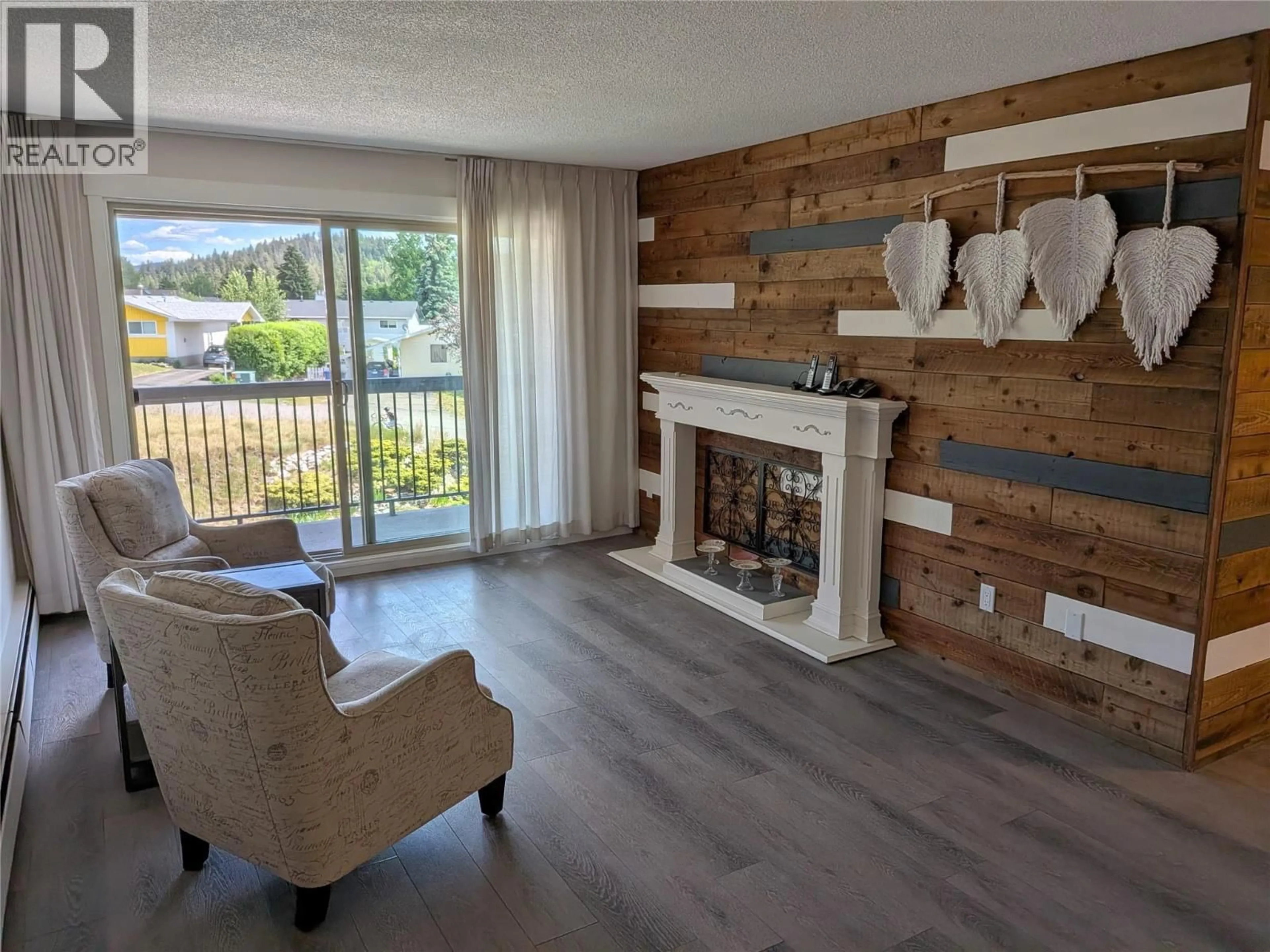 Living room with furniture, wood/laminate floor for 306 - 308 CHARTRAND AVENUE, Logan Lake British Columbia V0K1W0
