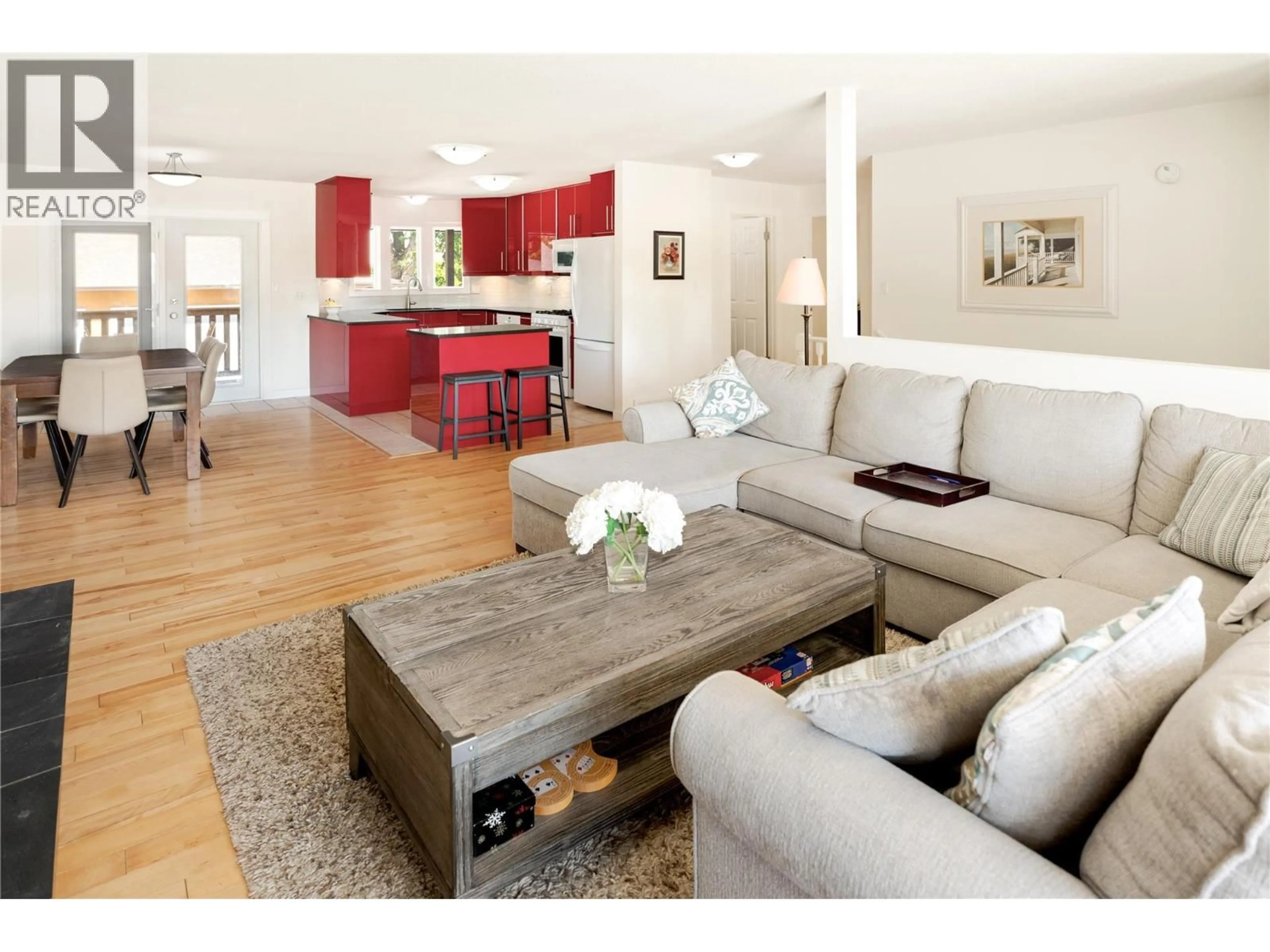 Living room with furniture, wood/laminate floor for 2425 O'REILLY ROAD, Kelowna British Columbia V1W2V7