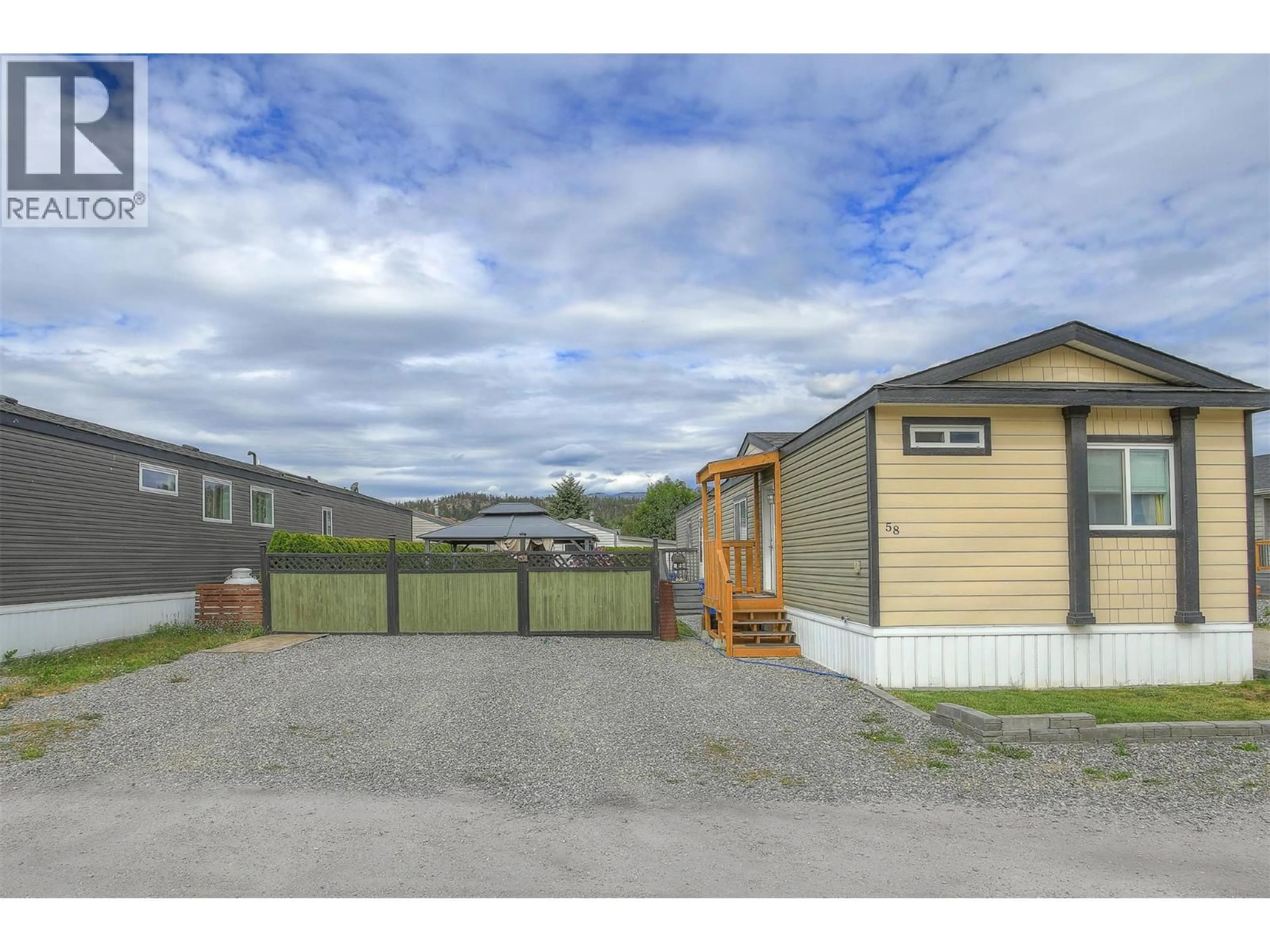 A pic from outside/outdoor area/front of a property/back of a property/a pic from drone, street for 58 - 8945 HIGHWAY 97 OTHER NORTH, Kelowna British Columbia V4V1E8