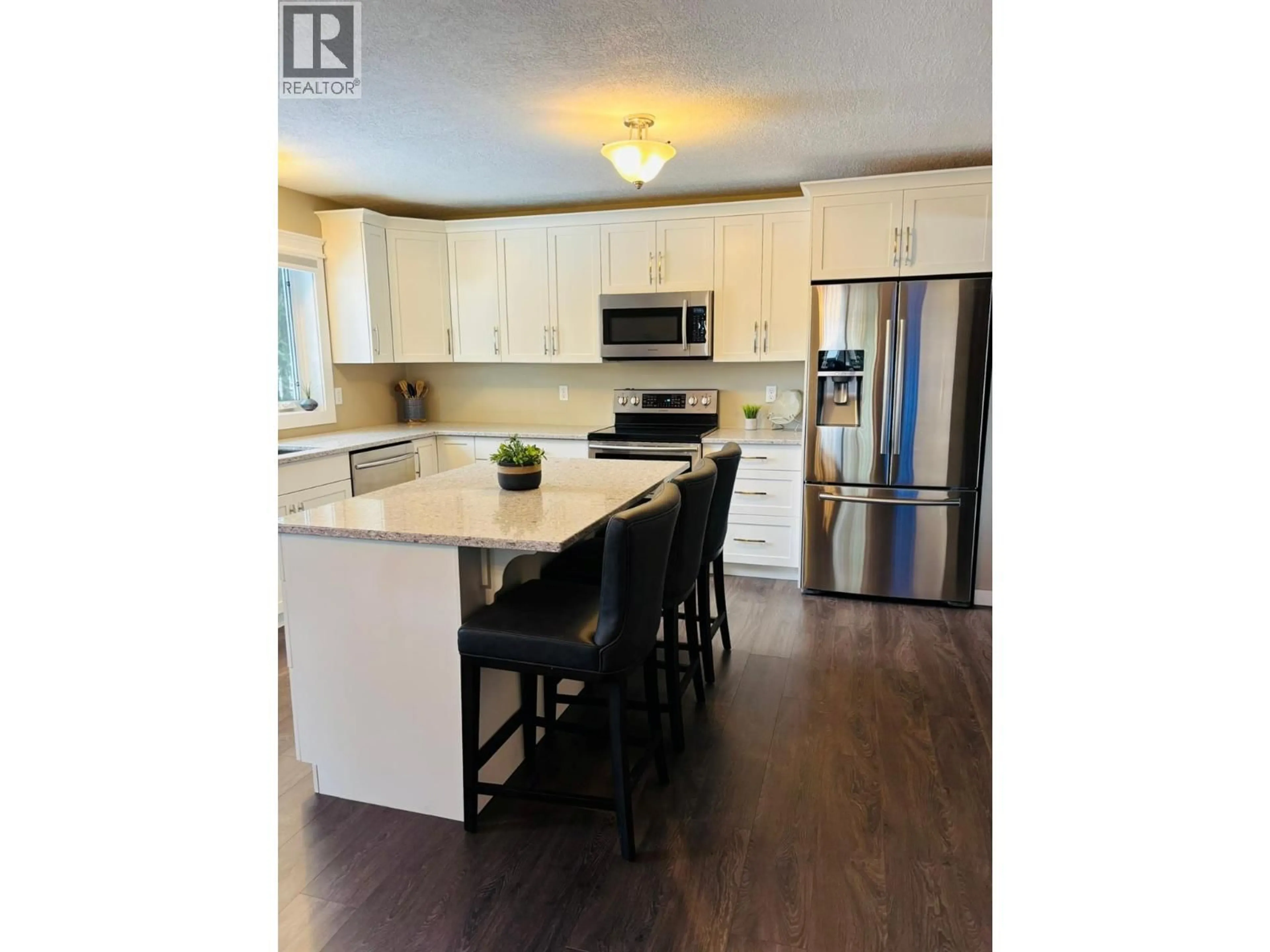 Open concept kitchen, wood/laminate floor for 610 10TH AVENUE NORTHWEST, Nakusp British Columbia V0G1R0