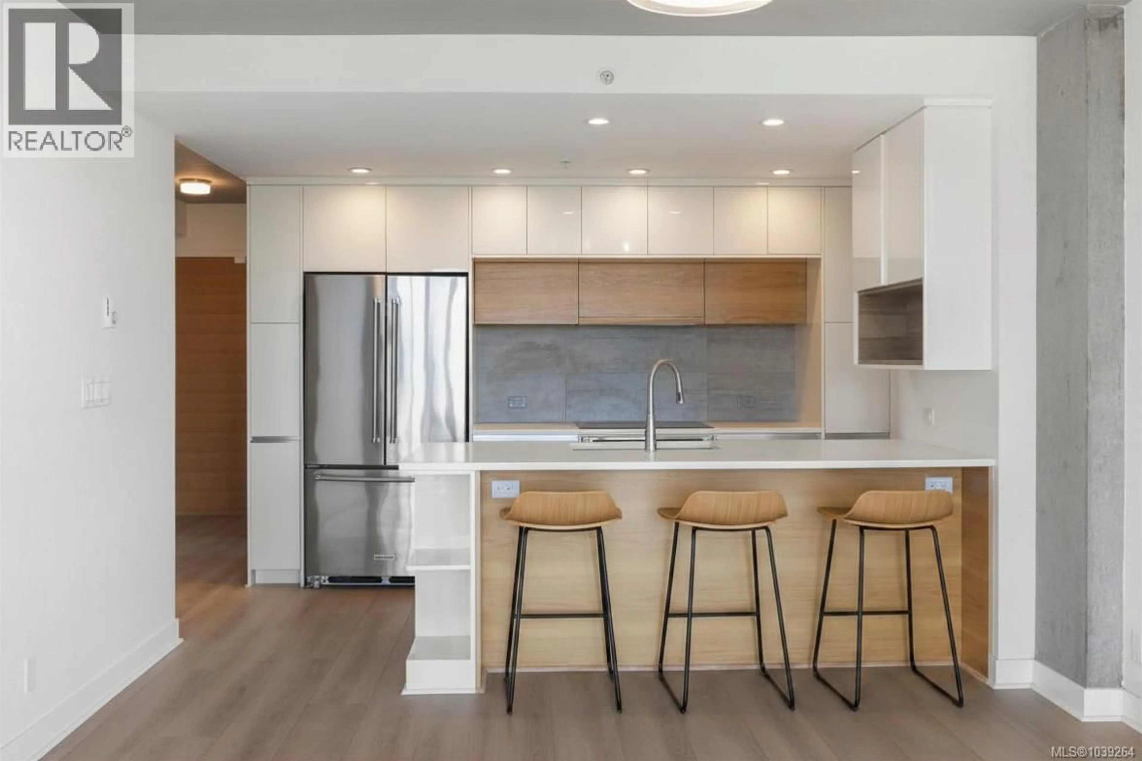 Open concept kitchen, wood/laminate floor for 713 - 989 JOHNSON STREET, Victoria British Columbia V8V0E3