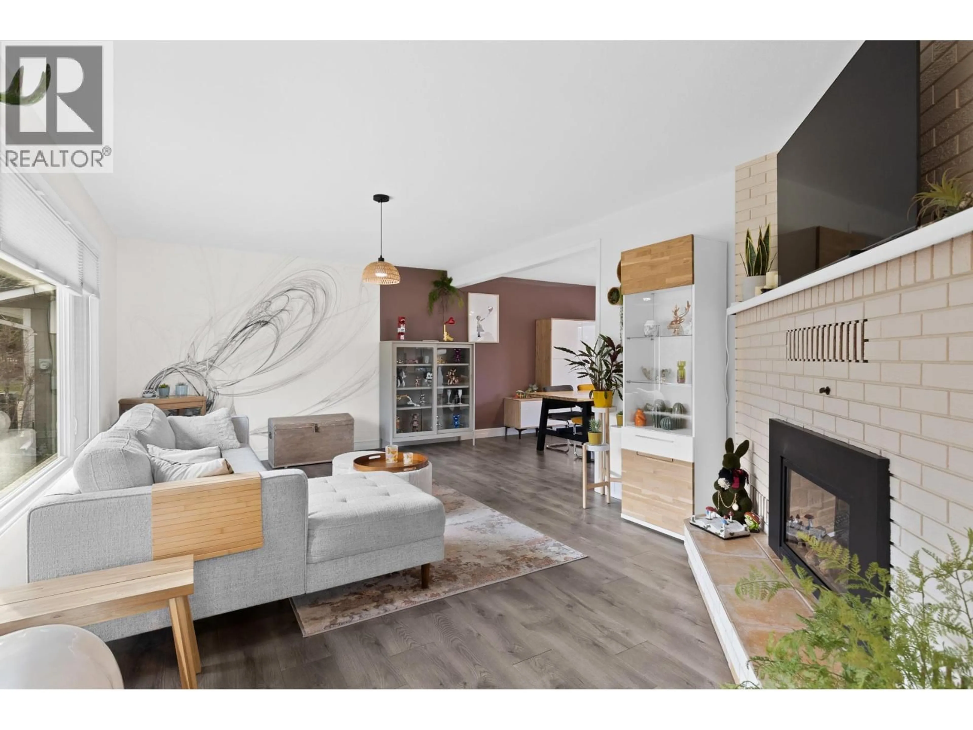 Living room with furniture, wood/laminate floor for 2426 COLLINGWOOD ROAD, West Kelowna British Columbia V1Z2C2