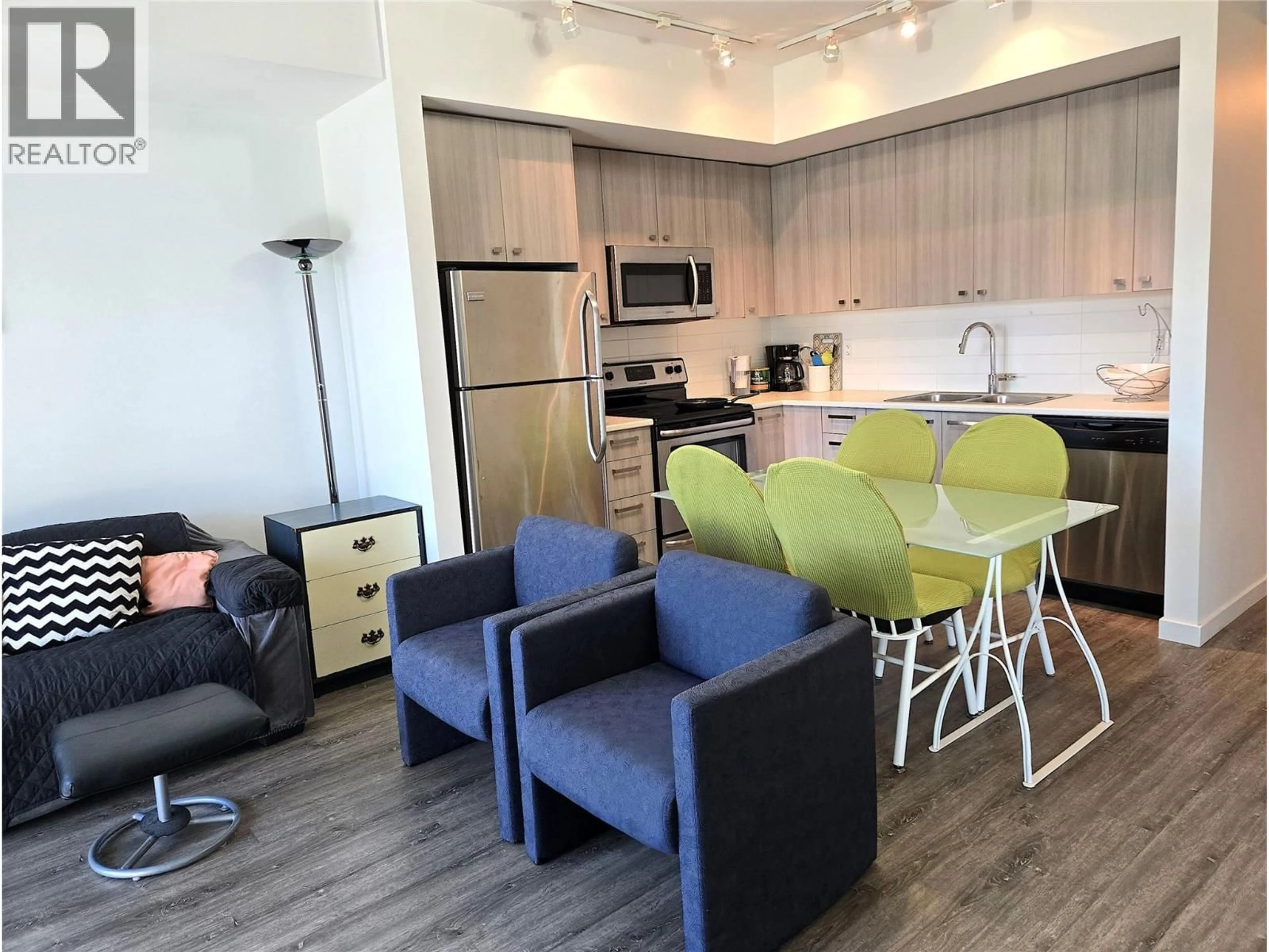 Open concept kitchen, wood/laminate floor for 202 - 935 ACADEMY WAY, Kelowna British Columbia V1V3C9