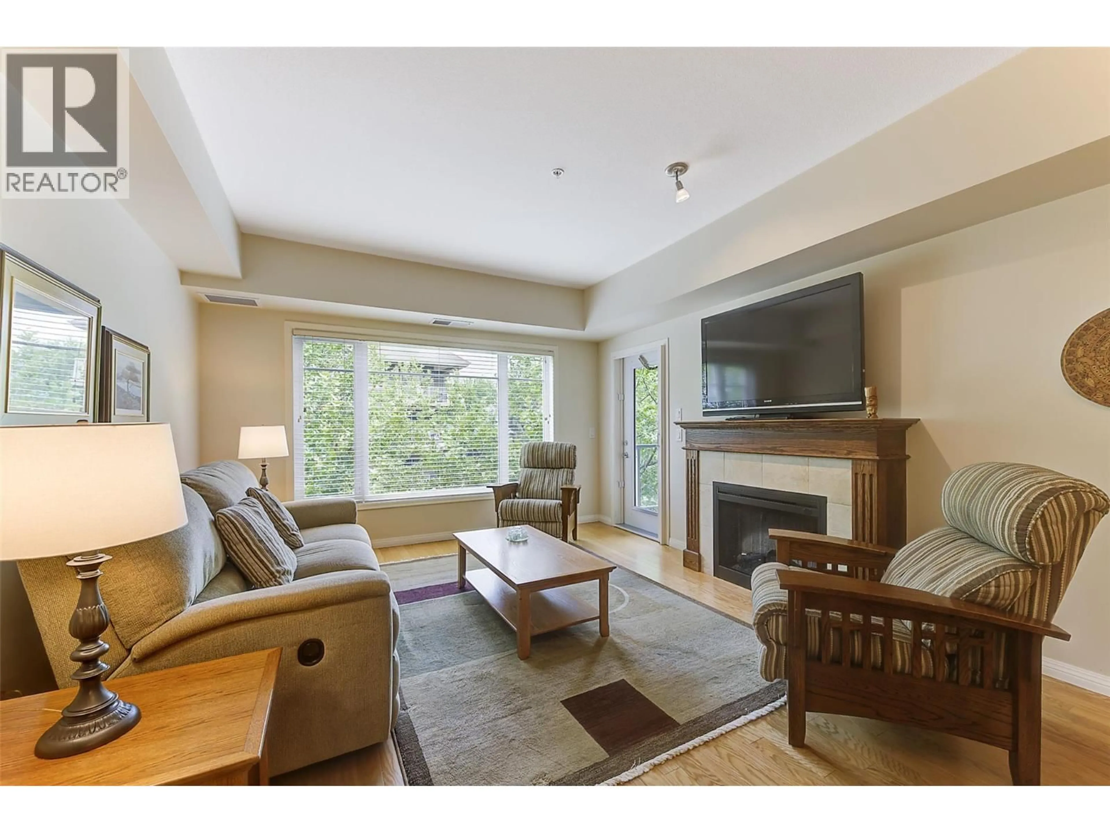 Living room with furniture, wood/laminate floor for 307 - 660 LEQUIME ROAD, Kelowna British Columbia V1W1A4
