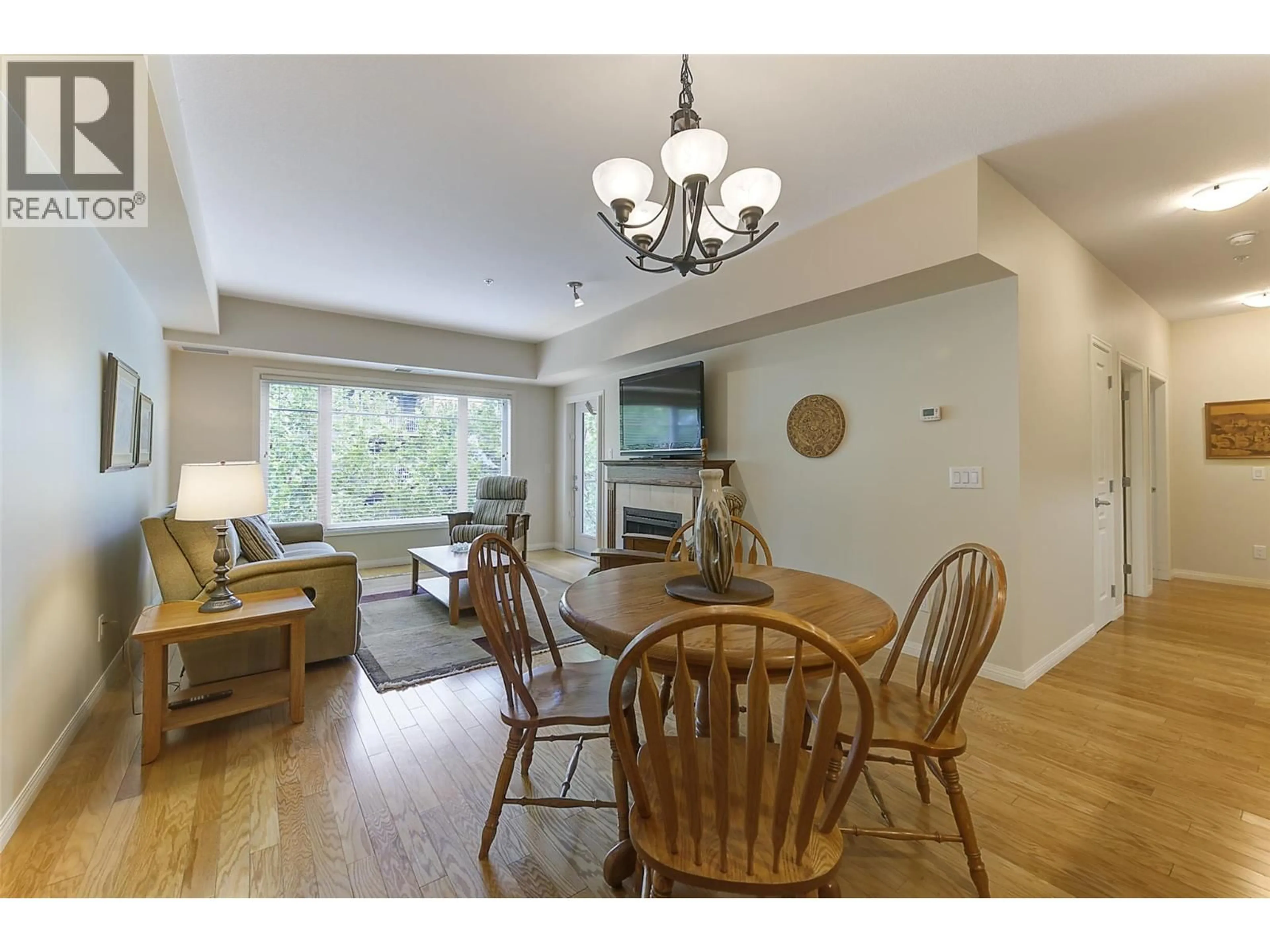Living room with furniture, wood/laminate floor for 307 - 660 LEQUIME ROAD, Kelowna British Columbia V1W1A4