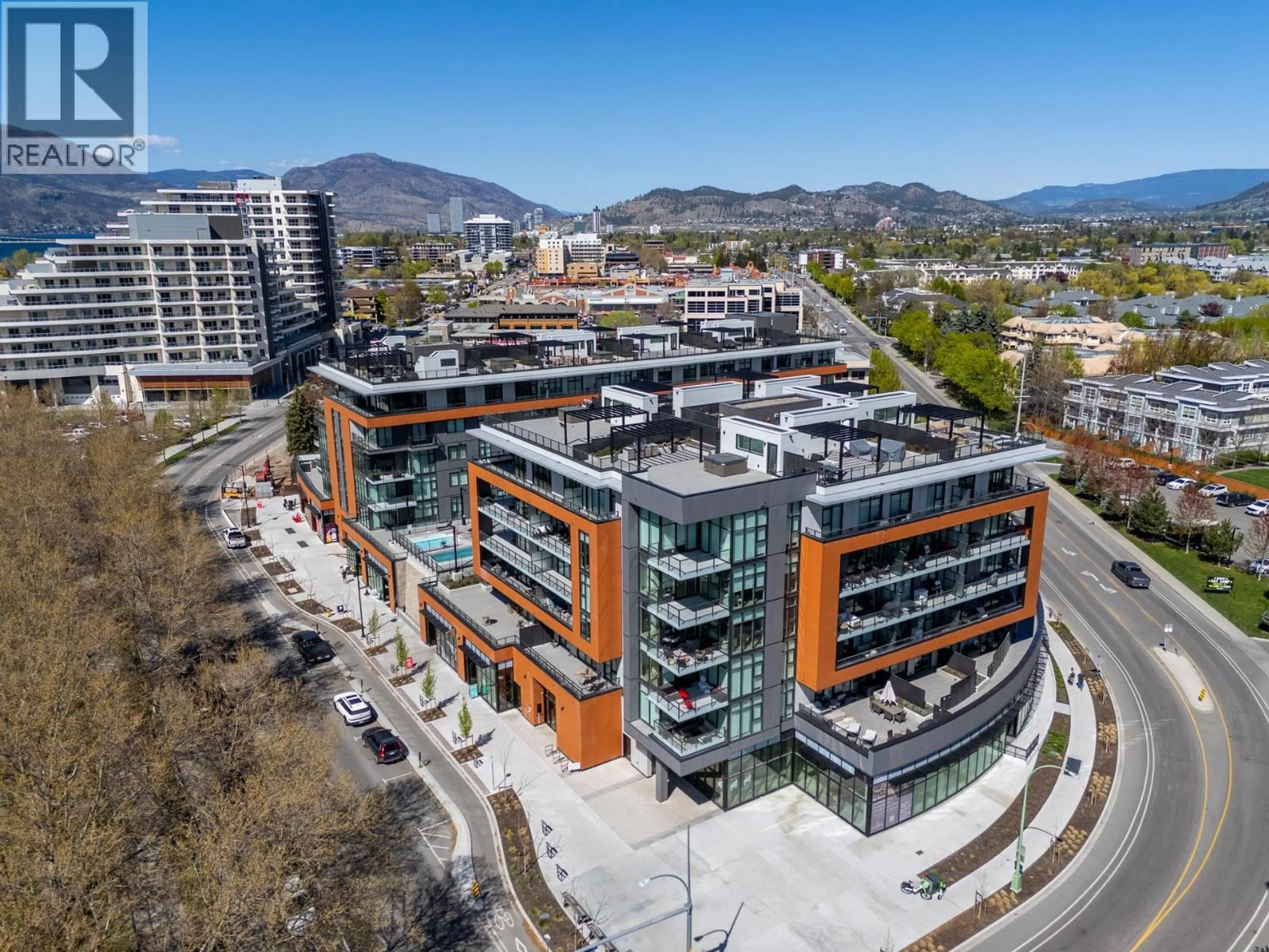 A pic from outside/outdoor area/front of a property/back of a property/a pic from drone, mountain view for 407 - 3389 LAKESHORE ROAD, Kelowna British Columbia V1W3S9