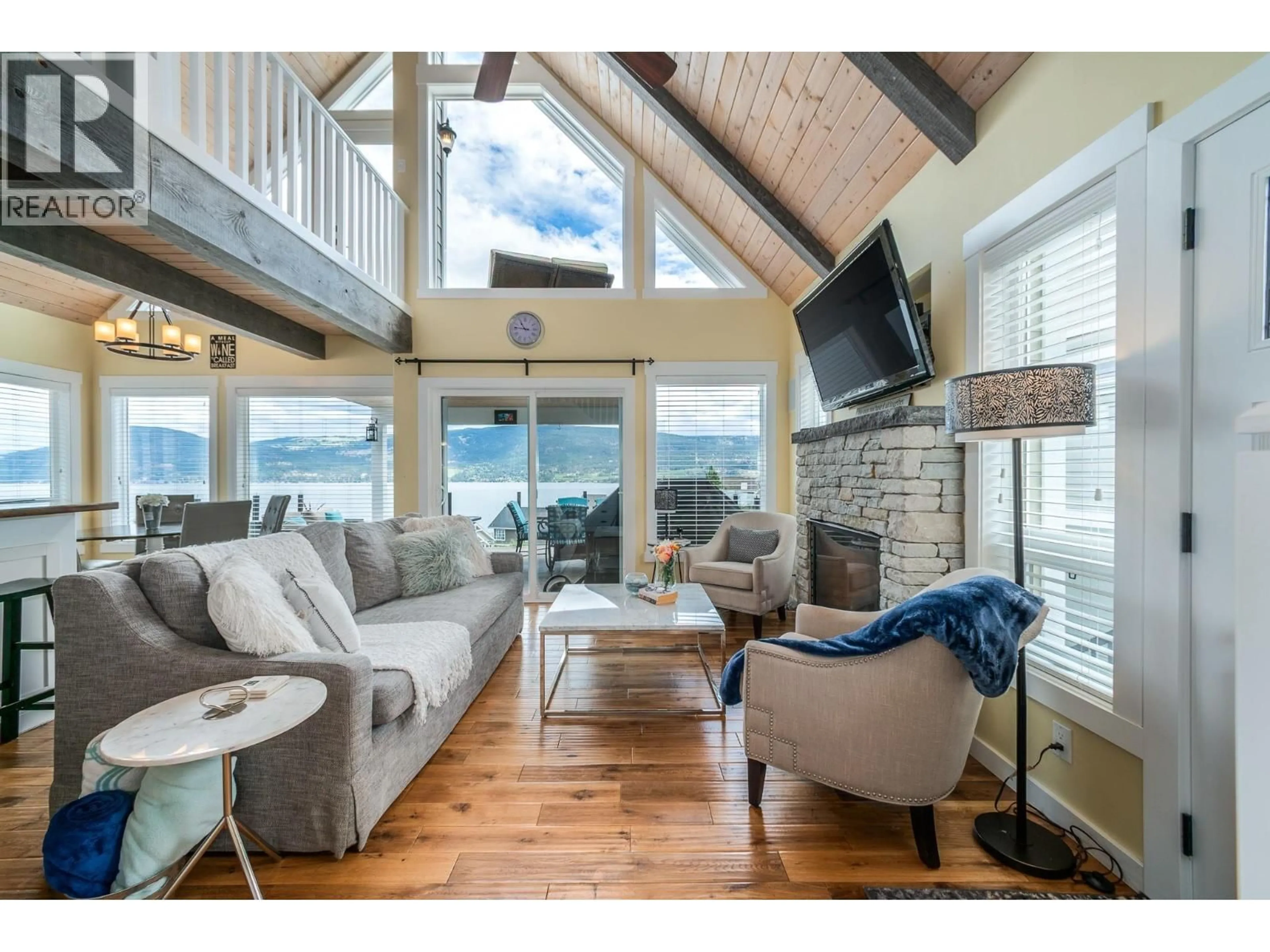 Living room with furniture, wood/laminate floor for 6877 SANTIAGO LOOP, Fintry British Columbia V1Z3R8
