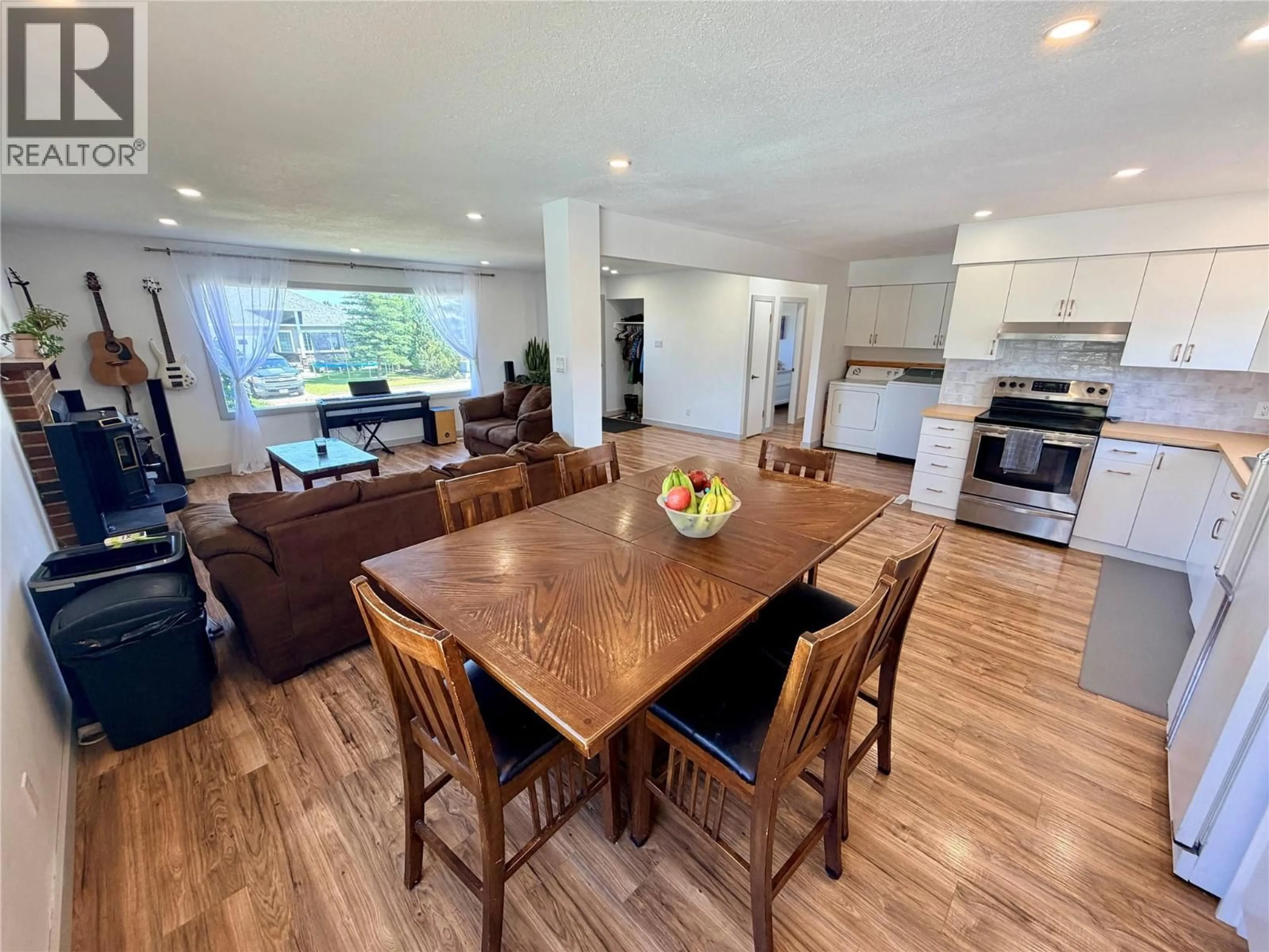 Open concept kitchen, wood/laminate floor for 1813 110 AVENUE, Dawson Creek British Columbia V1G0A3