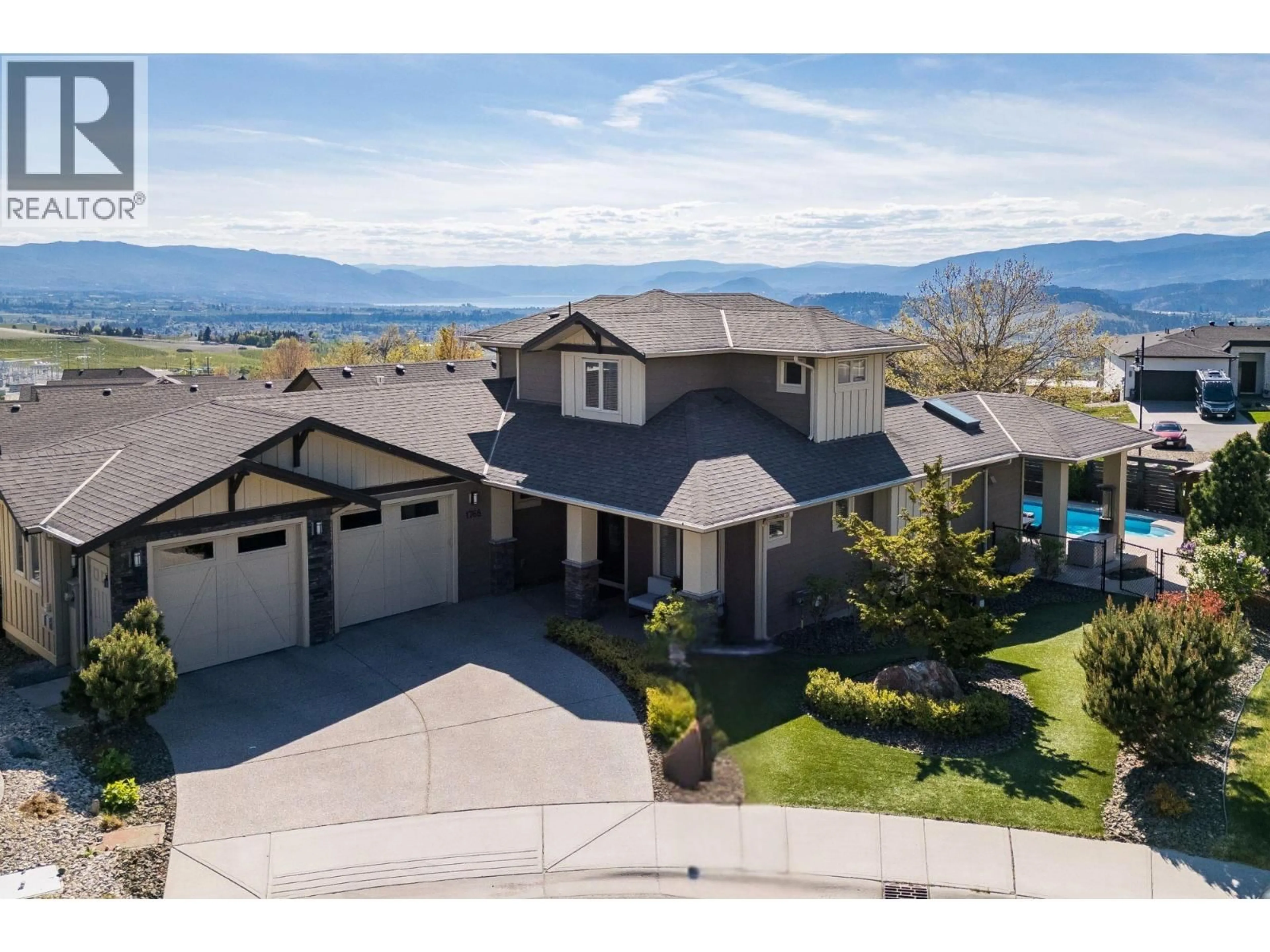 A pic from outside/outdoor area/front of a property/back of a property/a pic from drone, mountain view for 1768 SPLIT RAIL PLACE, Kelowna British Columbia V1P1R1
