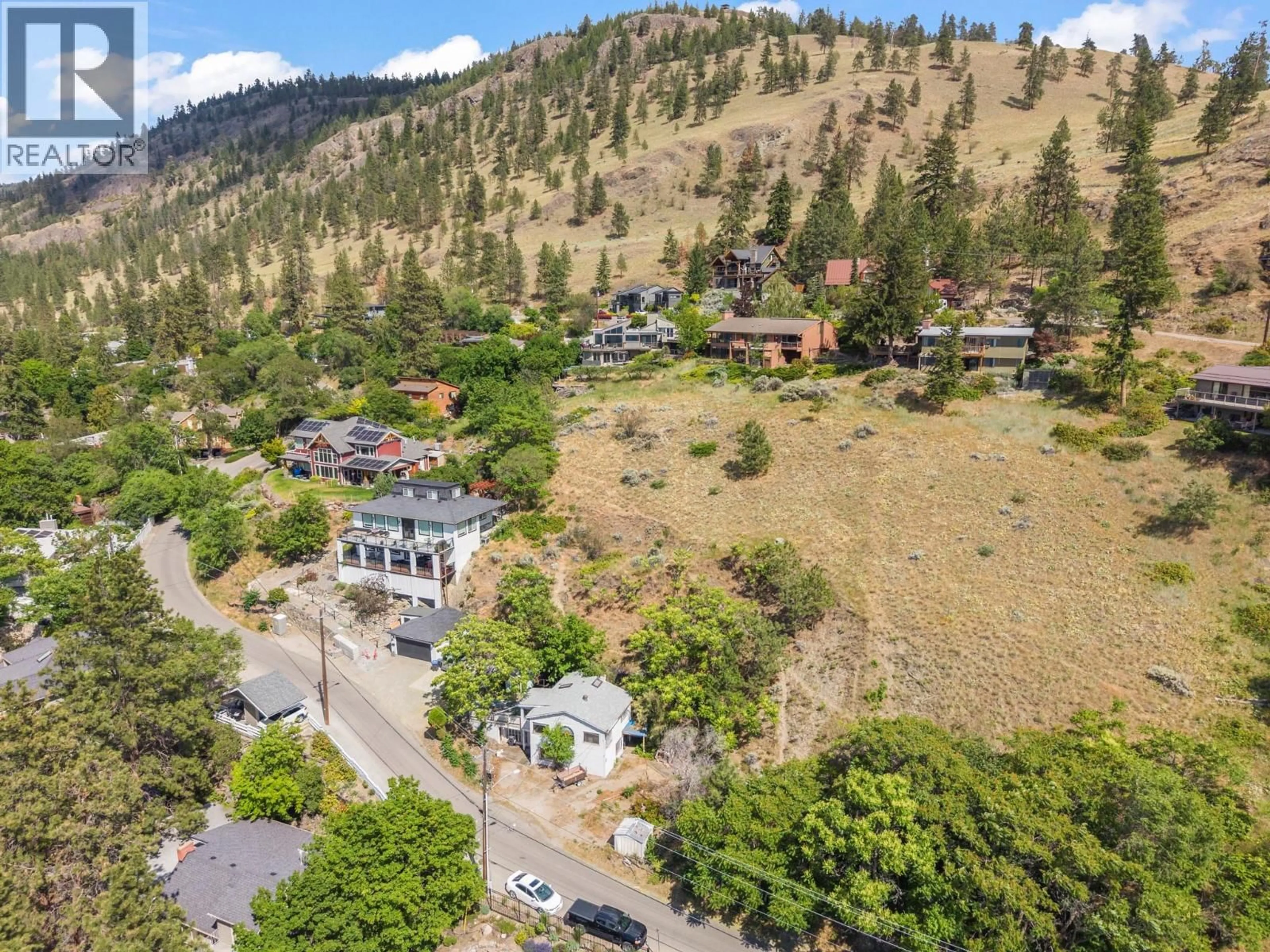 A pic from outside/outdoor area/front of a property/back of a property/a pic from drone, mountain view for 345 POPLAR POINT DRIVE, Kelowna British Columbia V1Y1Y2