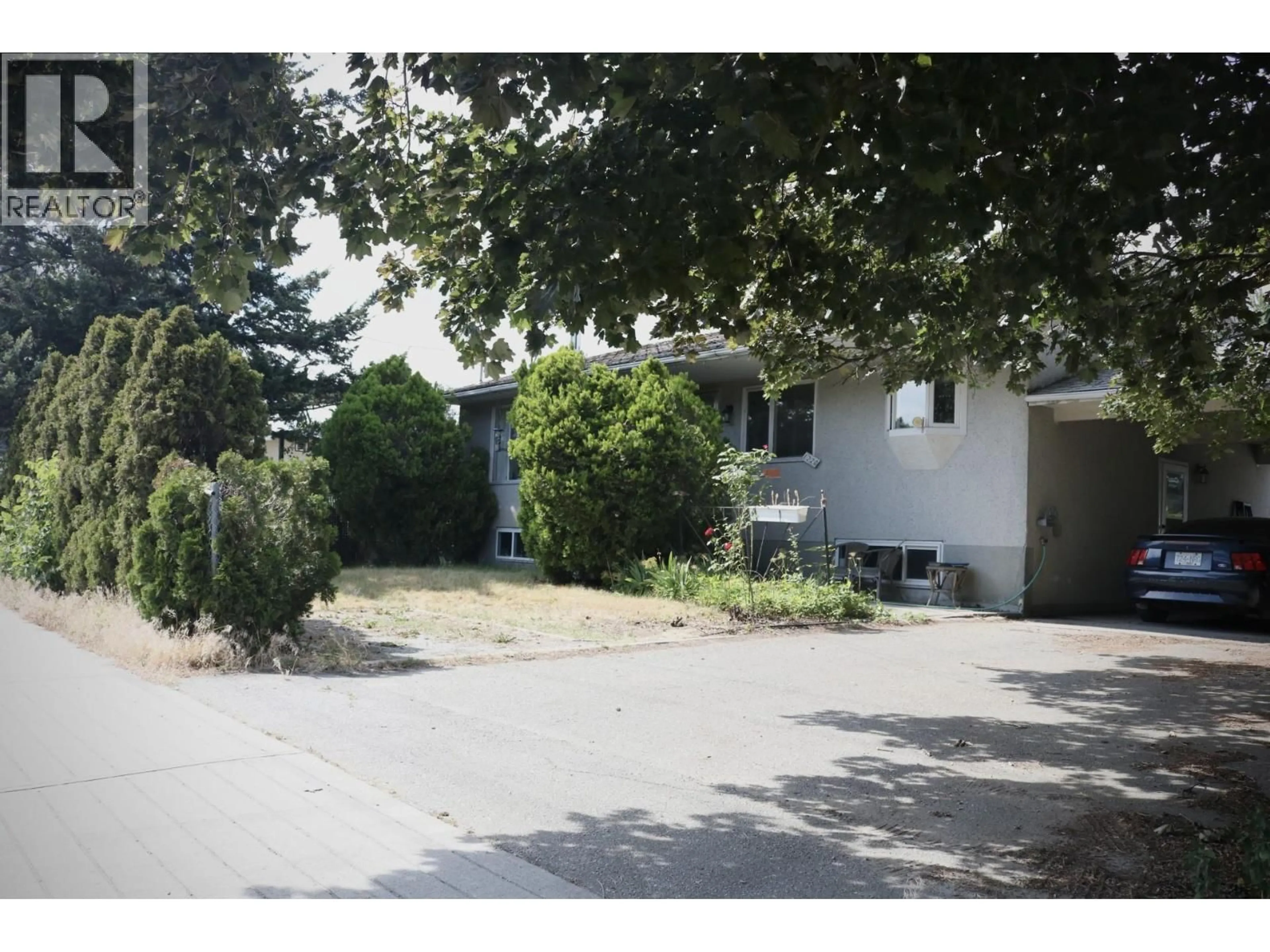 A pic from outside/outdoor area/front of a property/back of a property/a pic from drone, street for 1220 K.L.O ROAD, Kelowna British Columbia V1W3P9