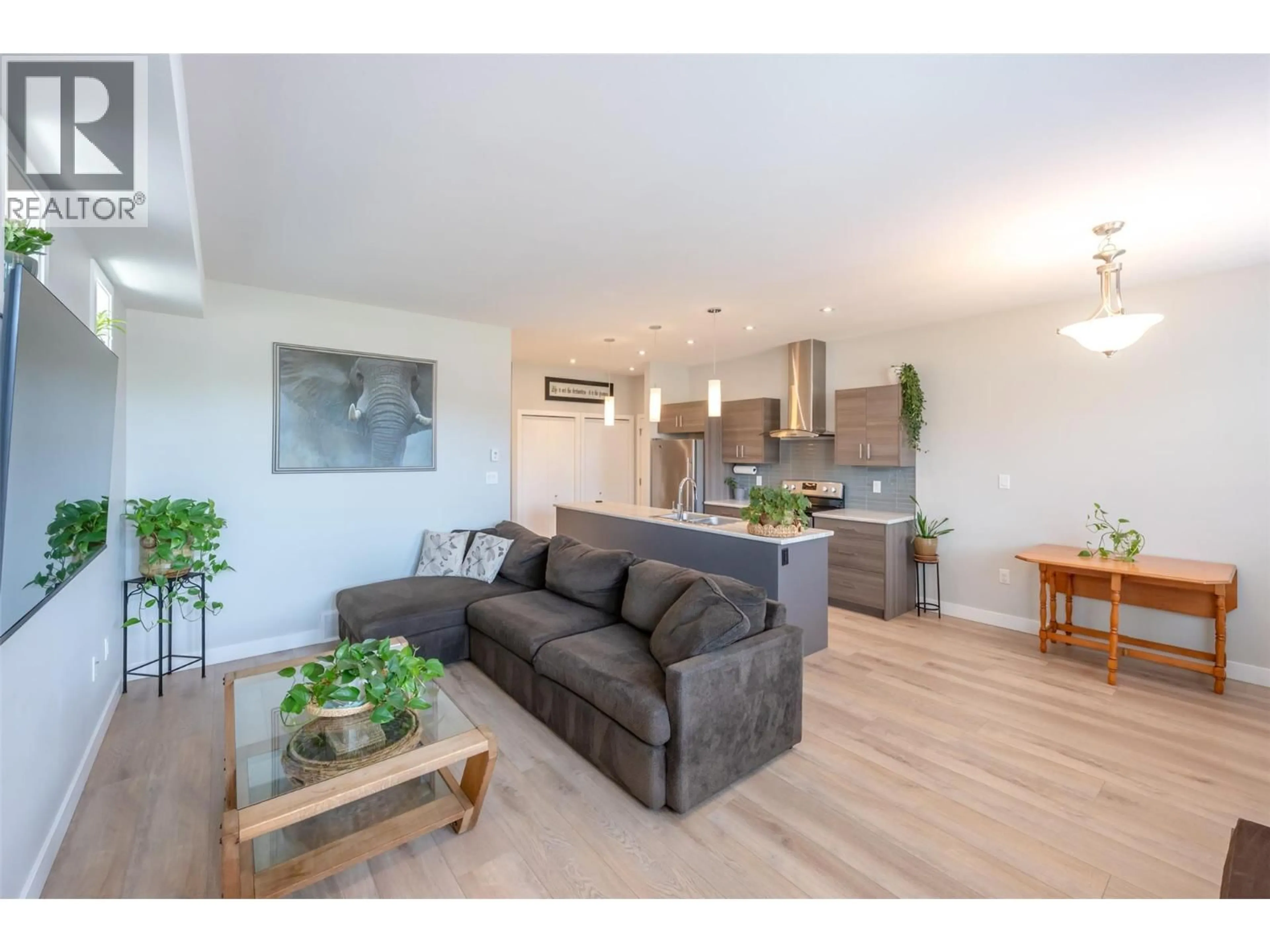Living room with furniture, wood/laminate floor for 102 - 457 NELSON AVENUE, Penticton British Columbia V2A2L3