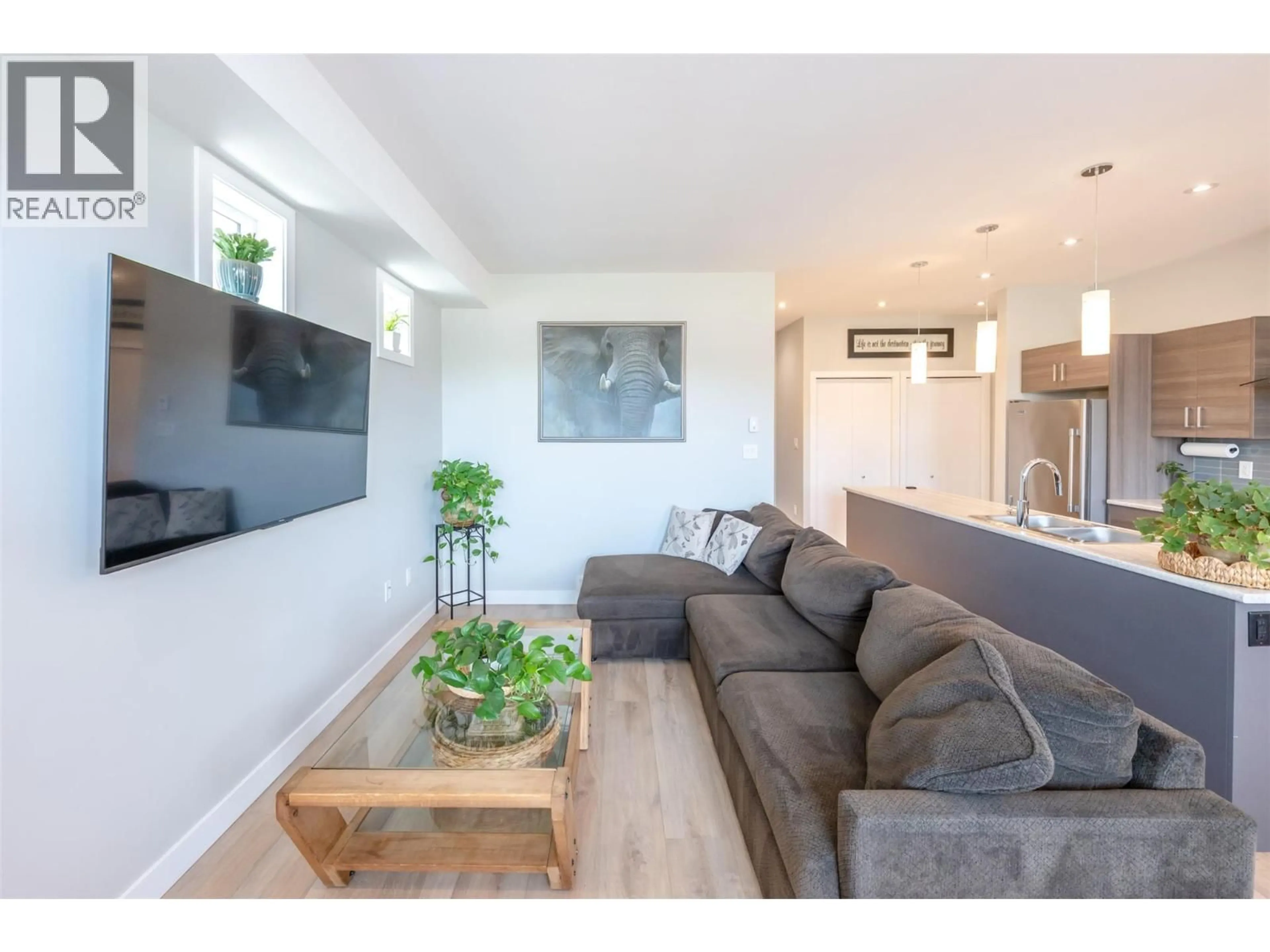 Living room with furniture, wood/laminate floor for 102 - 457 NELSON AVENUE, Penticton British Columbia V2A2L3