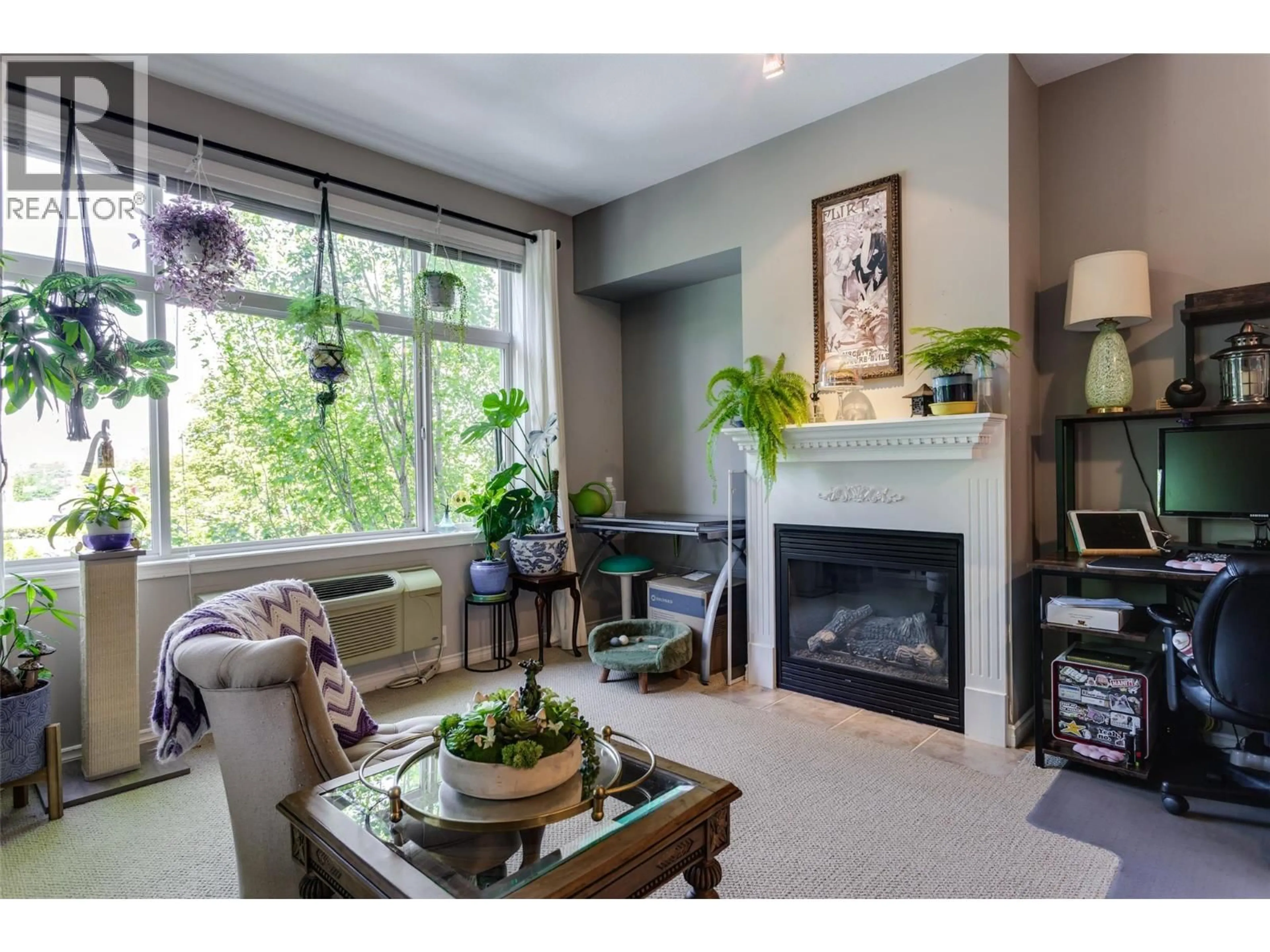 Living room with furniture, wood/laminate floor for 201 - 1235 KLO ROAD, Kelowna British Columbia V1W3N7