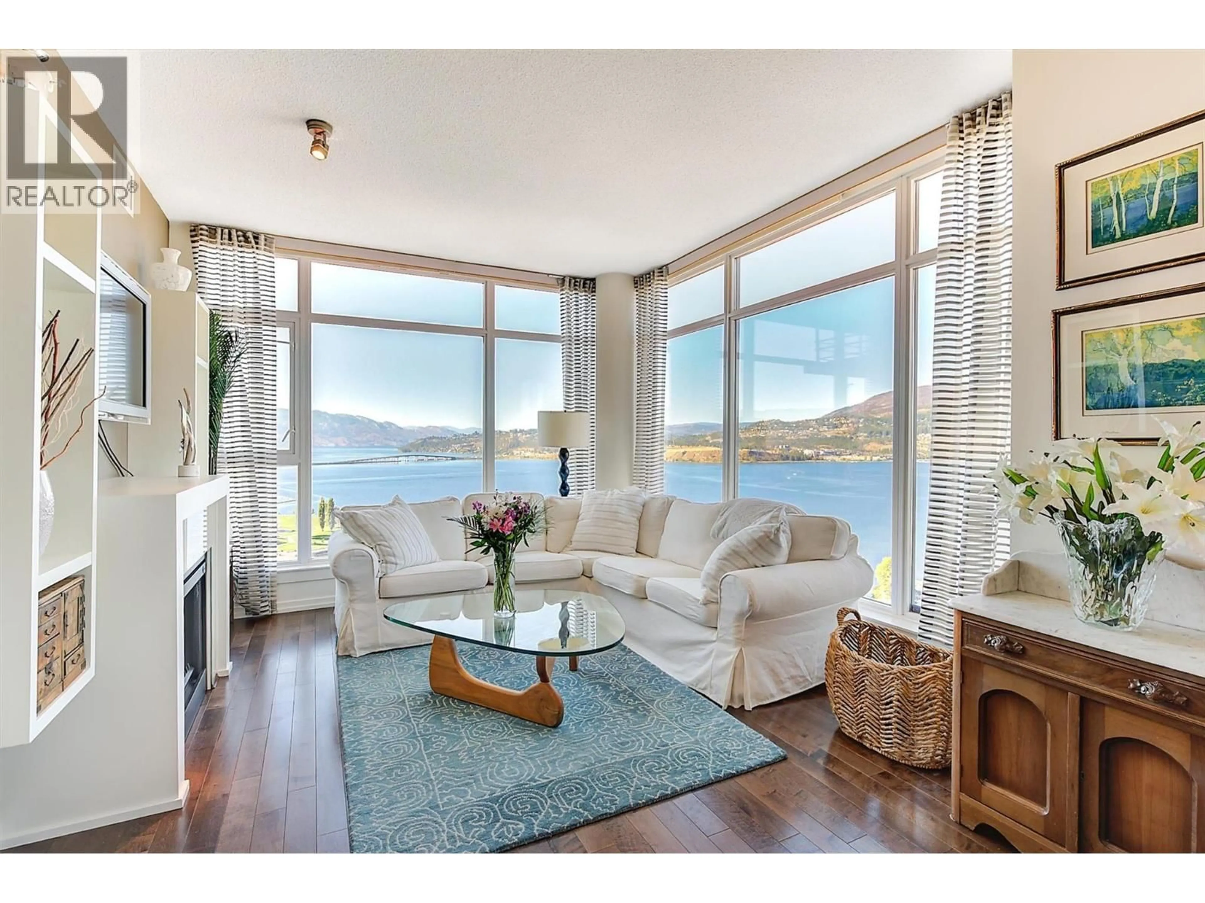 Living room with furniture, wood/laminate floor for 2408 - 1075 SUNSET DRIVE, Kelowna British Columbia V1Y9Y9