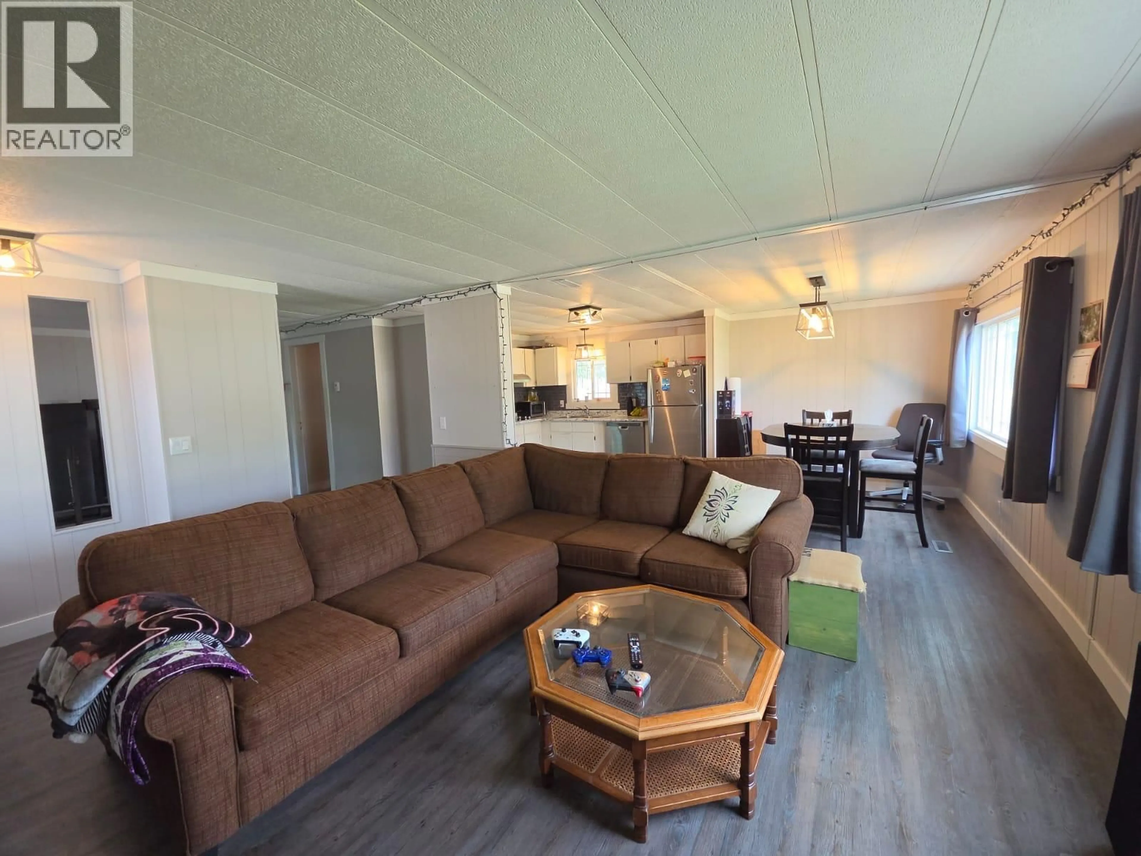 Living room with furniture, wood/laminate floor for 5117 43 STREET NORTHEAST, Chetwynd British Columbia V0C1J0