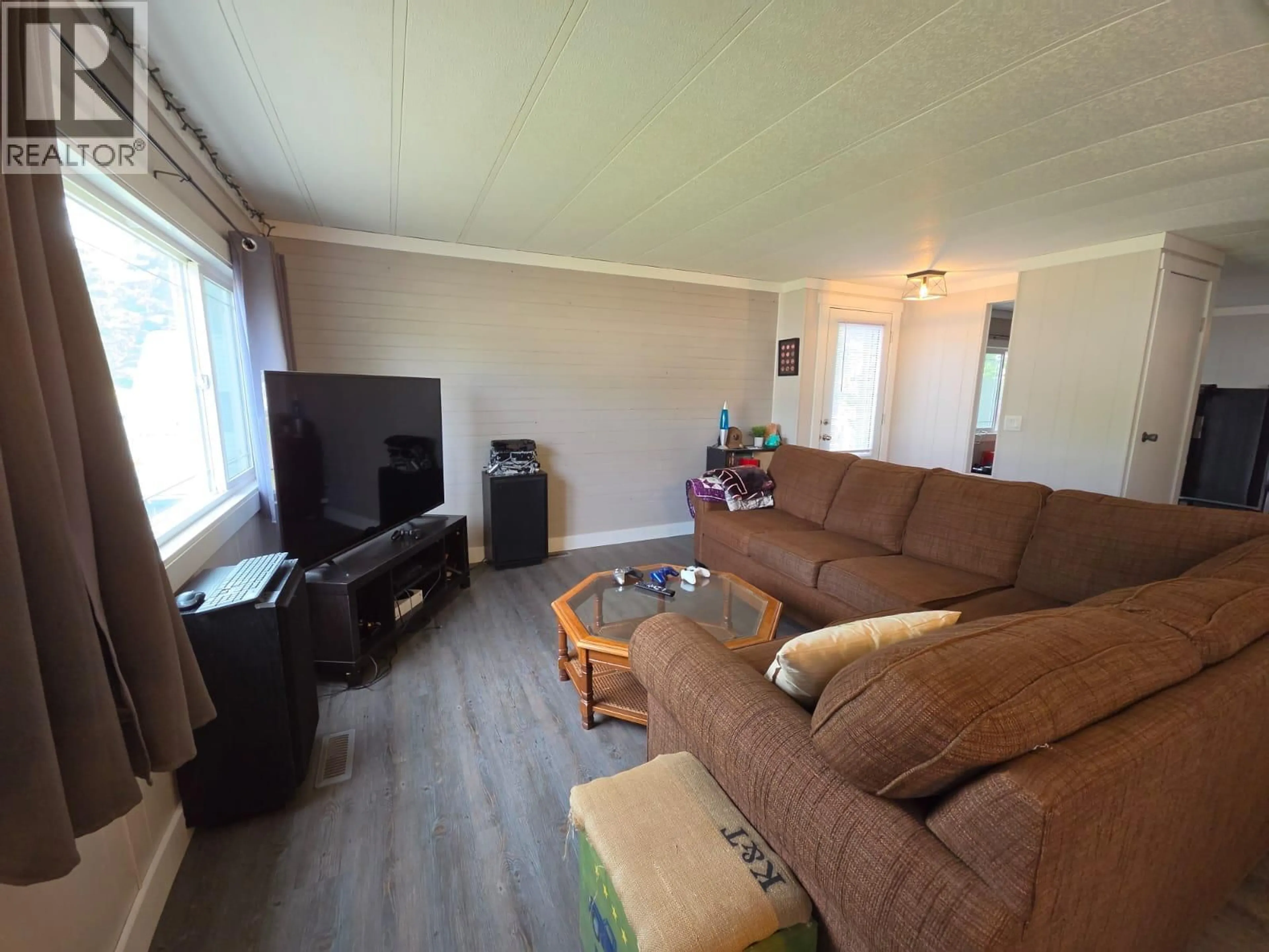Living room with furniture, wood/laminate floor for 5117 43 STREET NORTHEAST, Chetwynd British Columbia V0C1J0