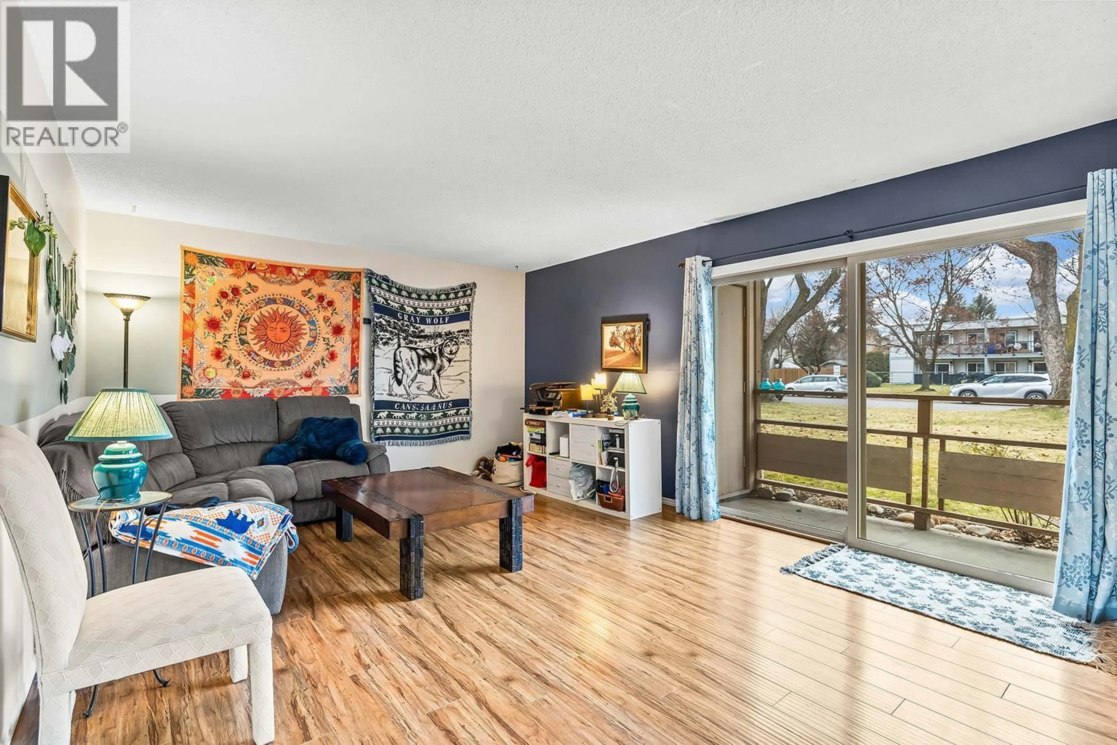 Living room with furniture, wood/laminate floor for 103A - 880 BADKE ROAD, Kelowna British Columbia V1X5Z6