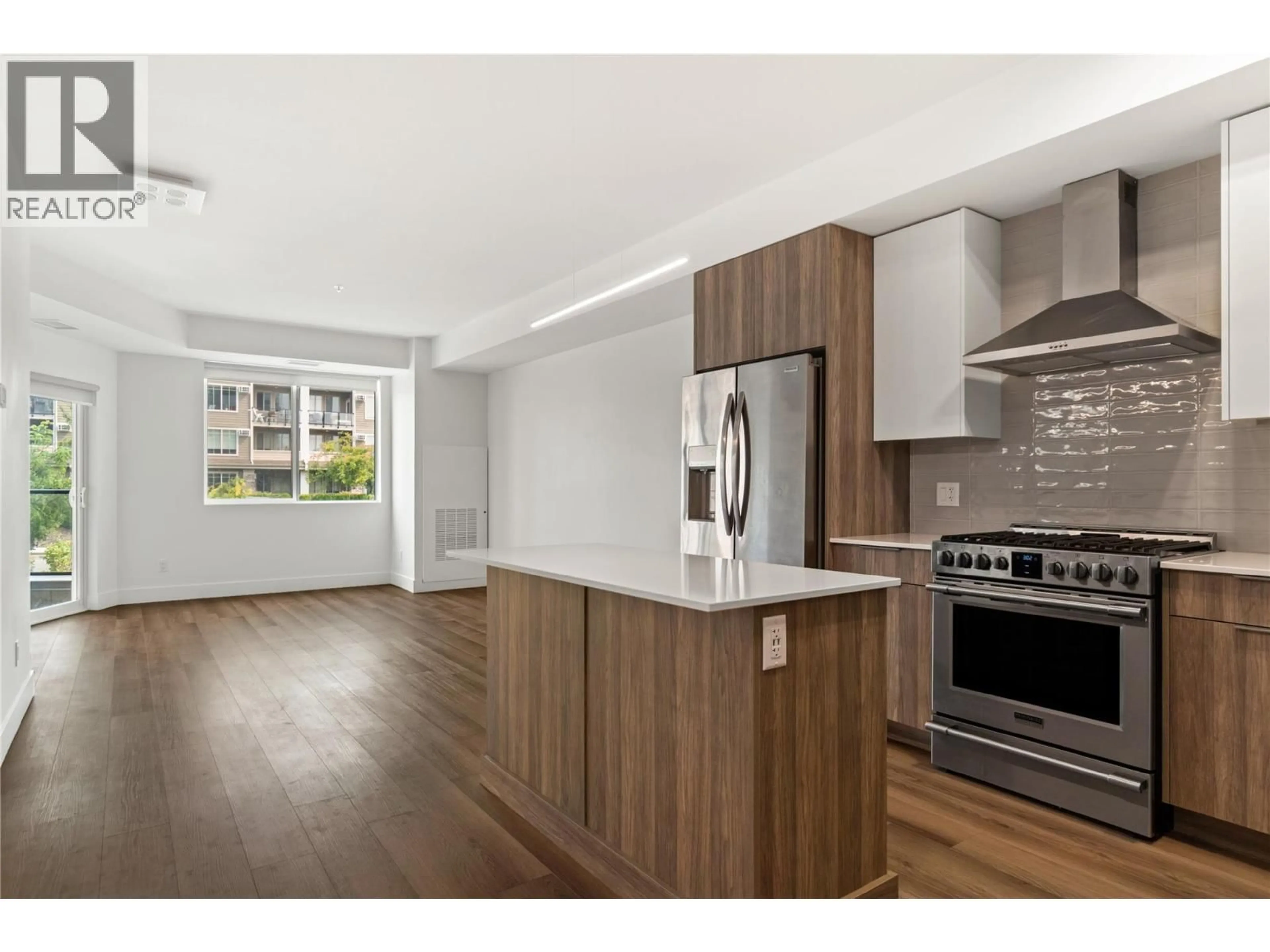 Open concept kitchen, wood/laminate floor for 201 - 3642 MISSION SPRINGS DRIVE, Kelowna British Columbia V1W0E1