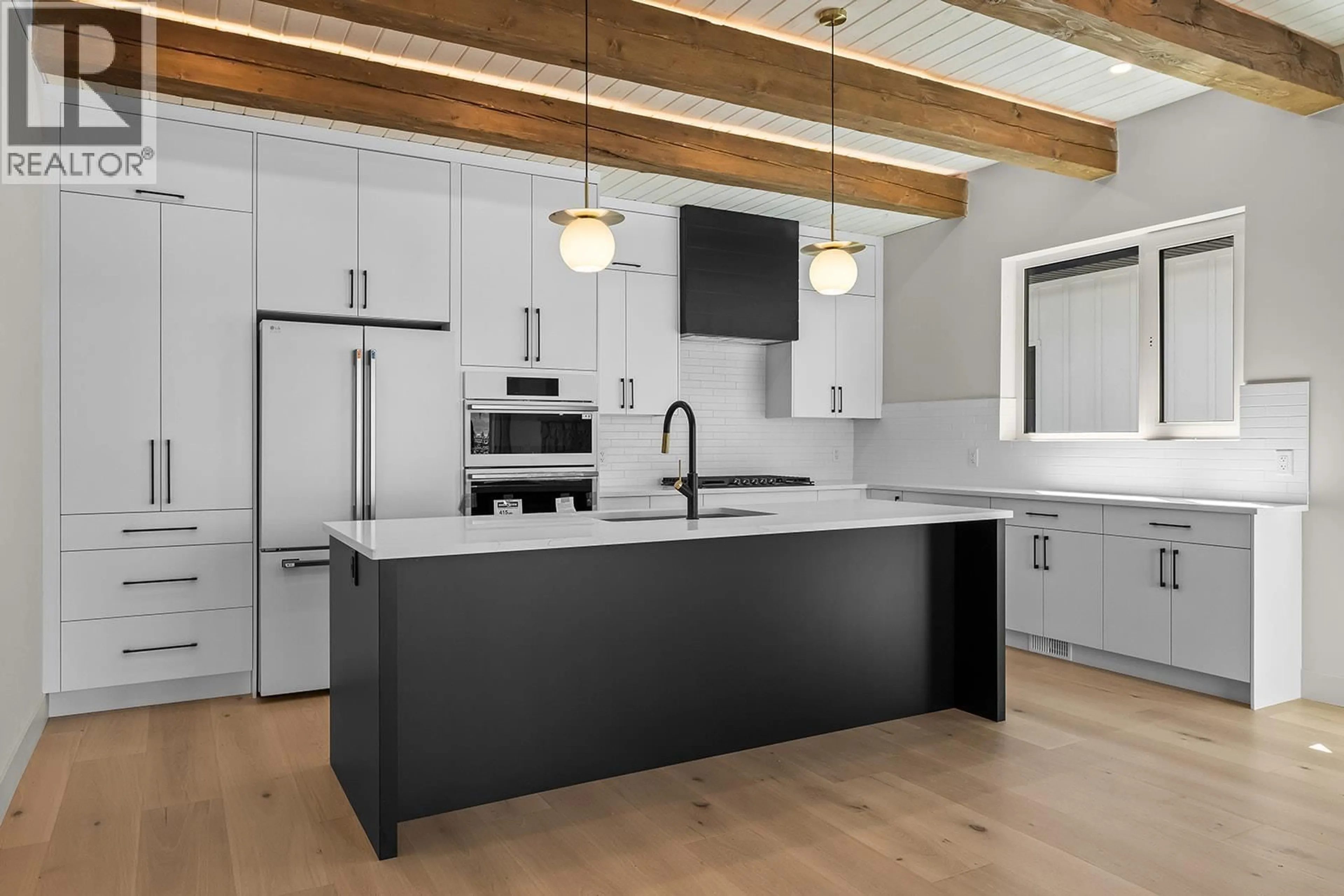 Open concept kitchen, wood/laminate floor for 2 - 4495 WALKER ROAD, Kelowna British Columbia V1W1G8