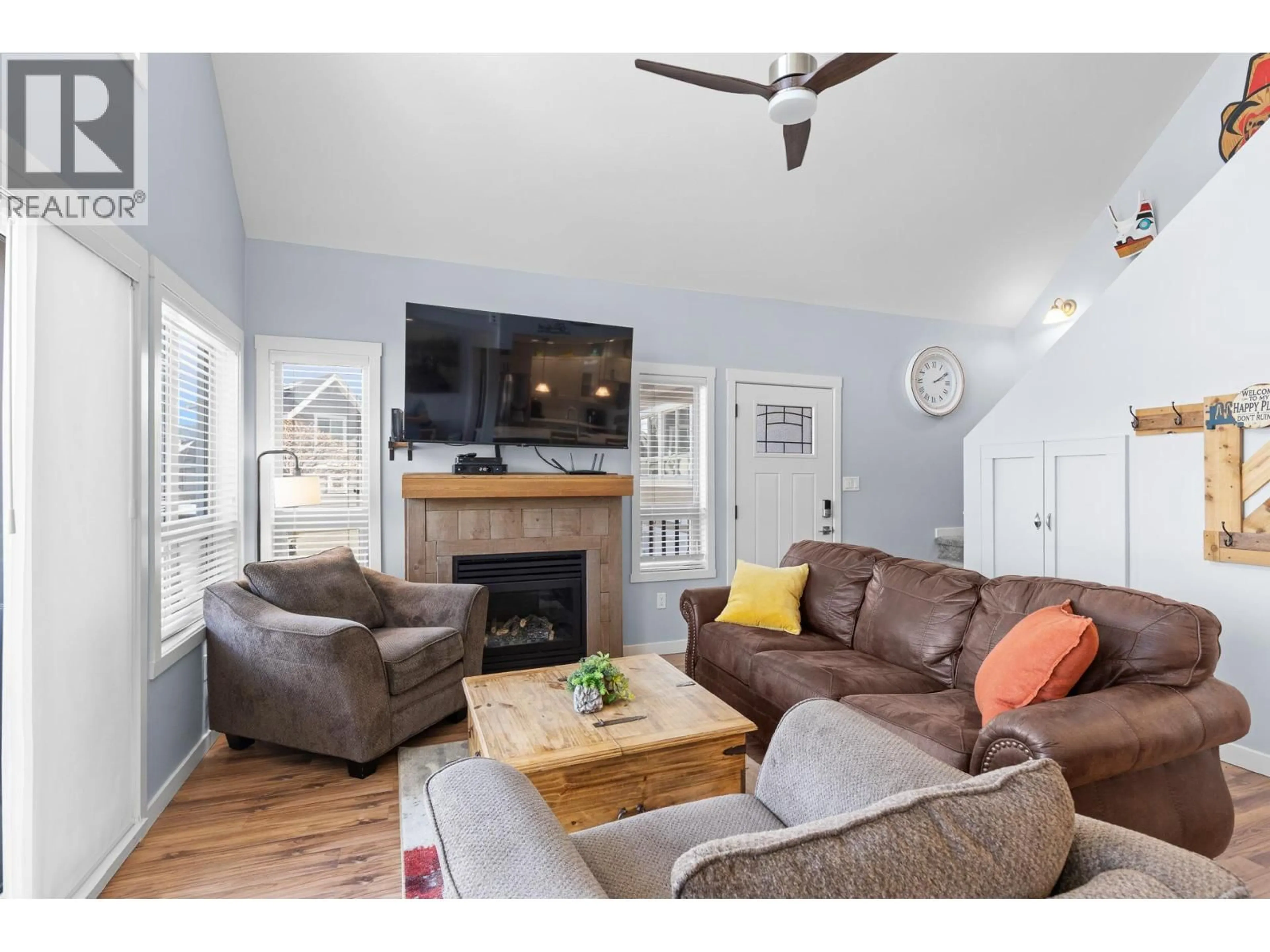 Living room with furniture, wood/laminate floor for 179 - 6844 SANTIAGO LOOP, Kelowna British Columbia V1Z3R8